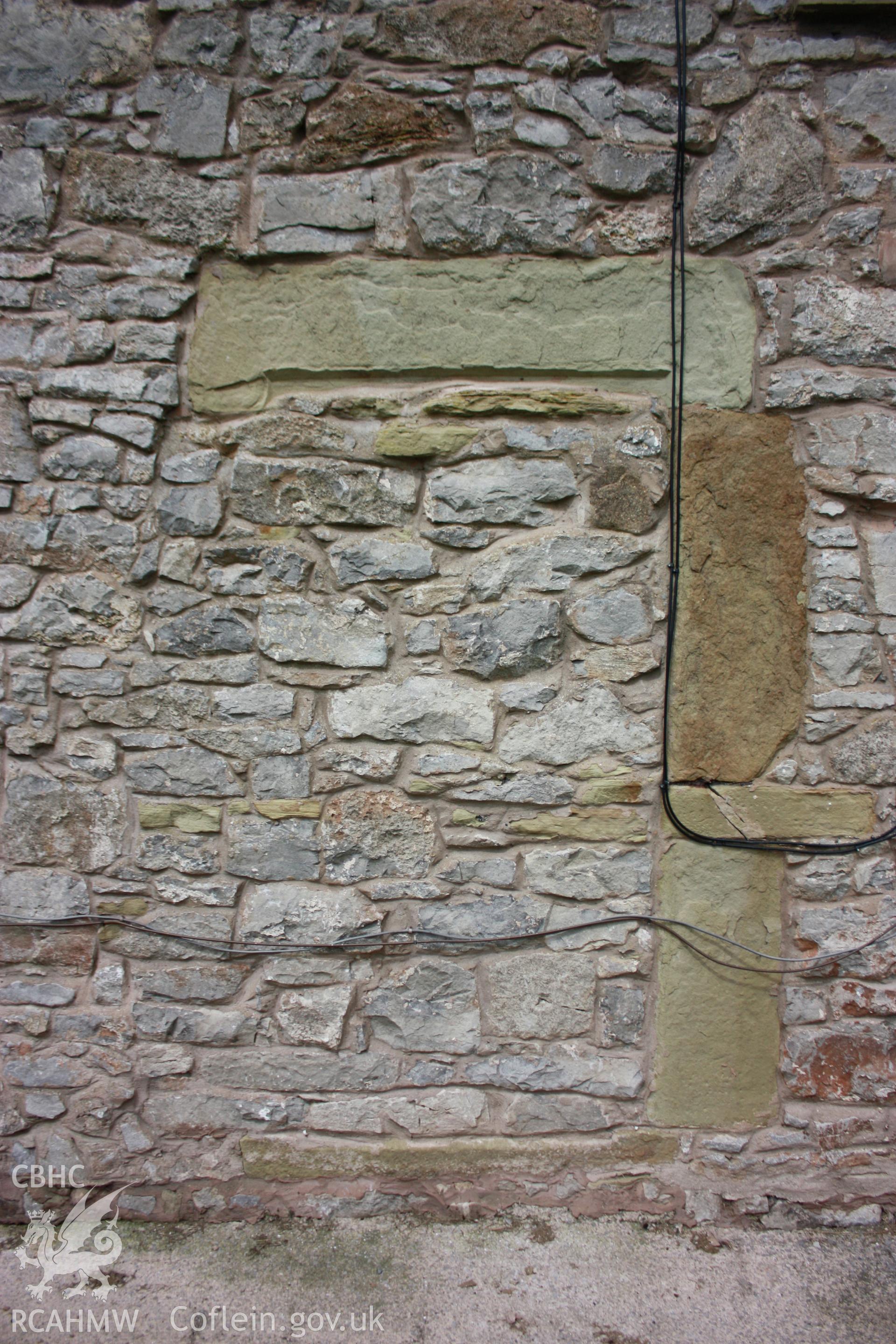 Exterior, view of south elevation's blocked stone doorway.