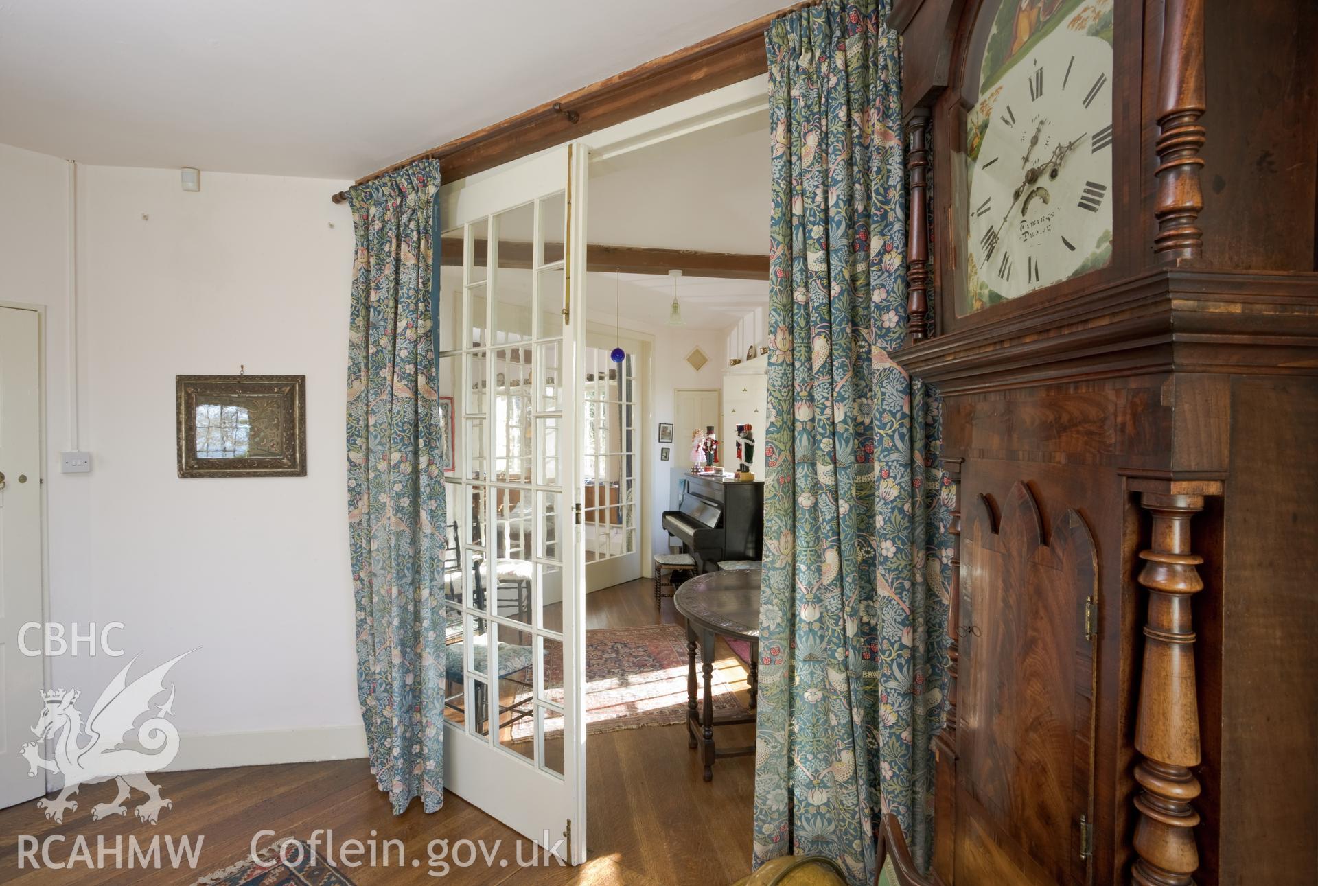 Dining room and central room from the living-room, dividing doors partially open.