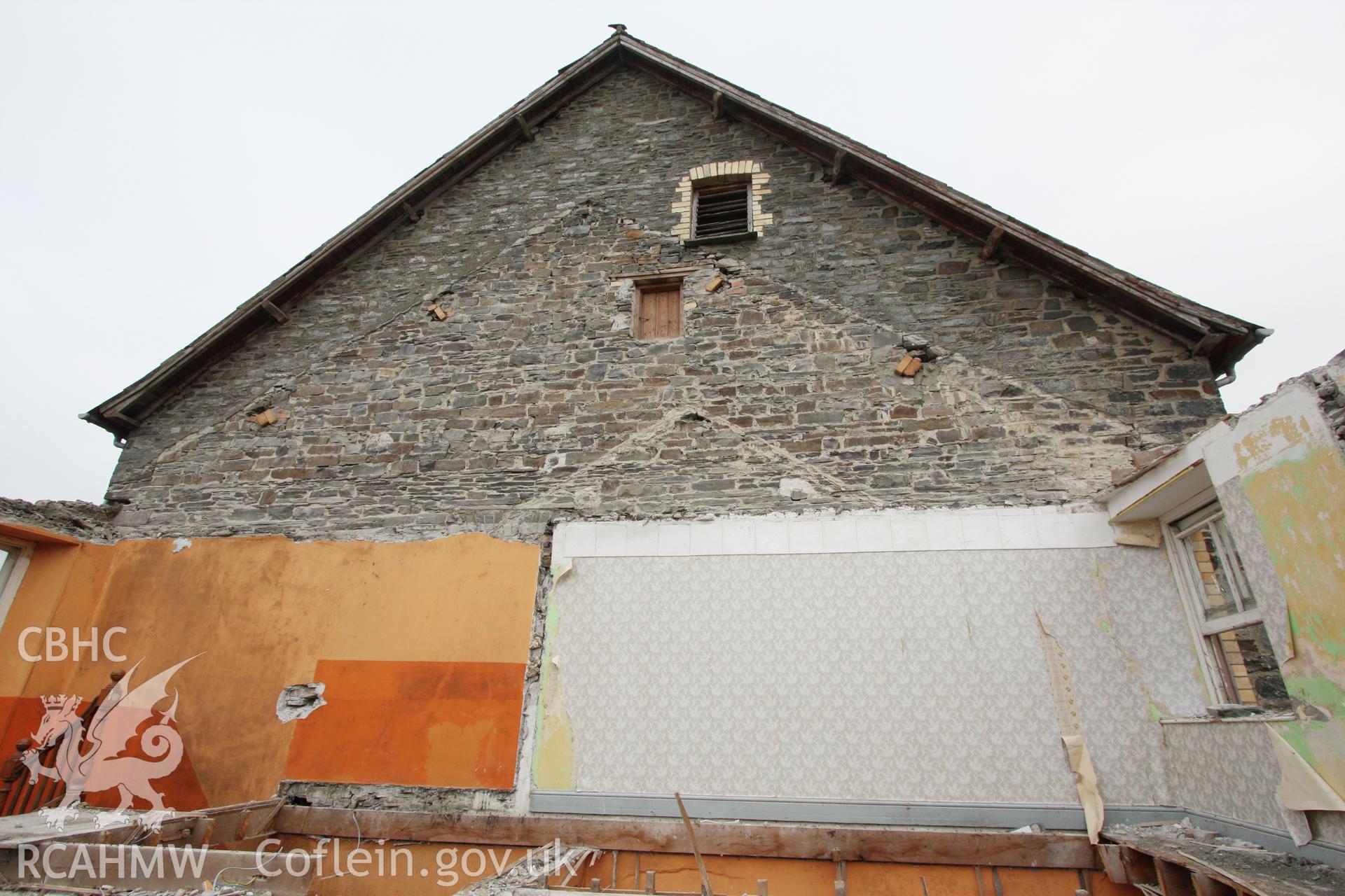 Chapel house attached to Gosen Chapel, Rhydyfelin during demolition, view looking east showing the phasing of gables against the west (rear) wall of Gosen Chapel.