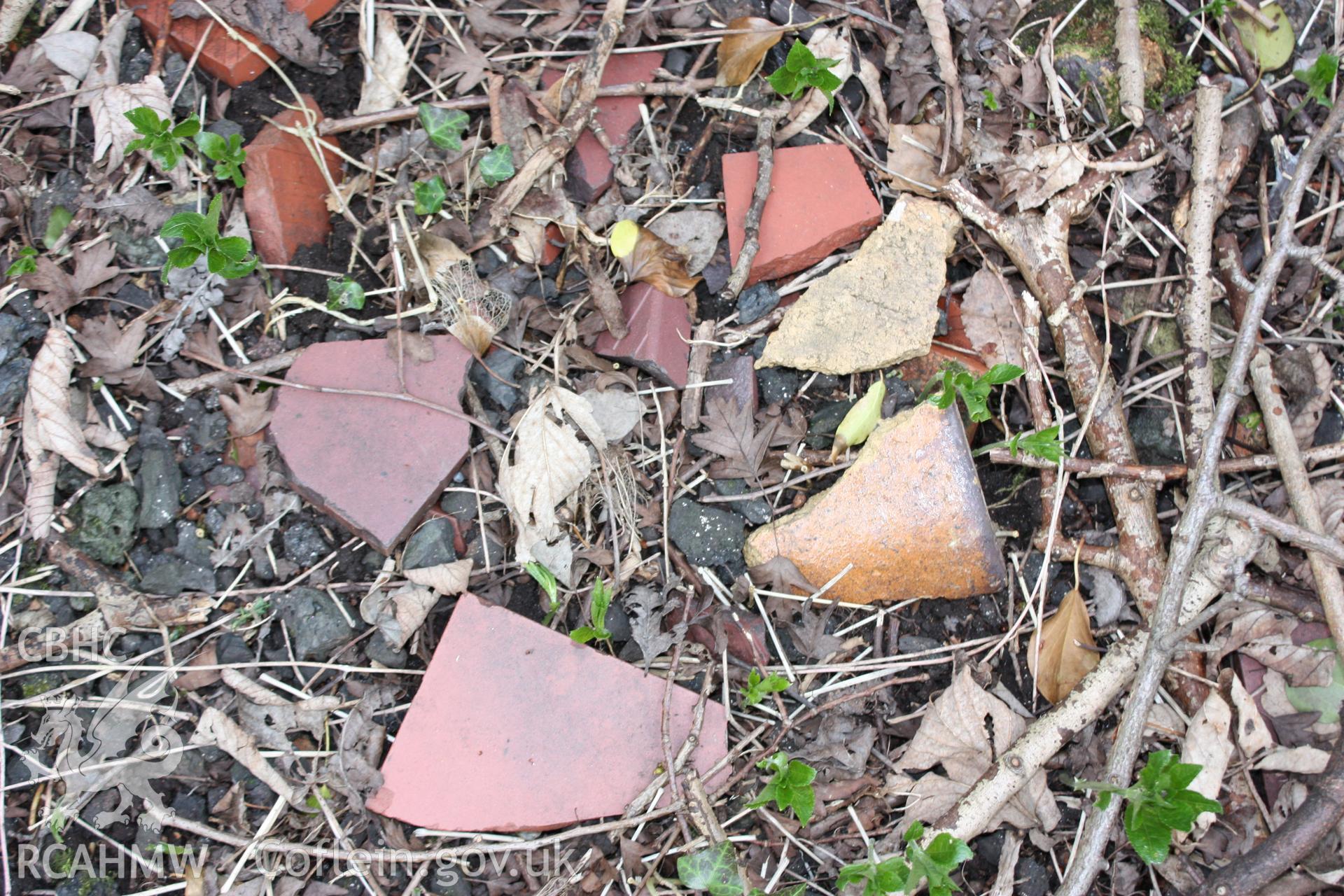 Remains of terracotta floor tiles and buff clay sanitary pipes at Tref-y-nant Fireclay Works.