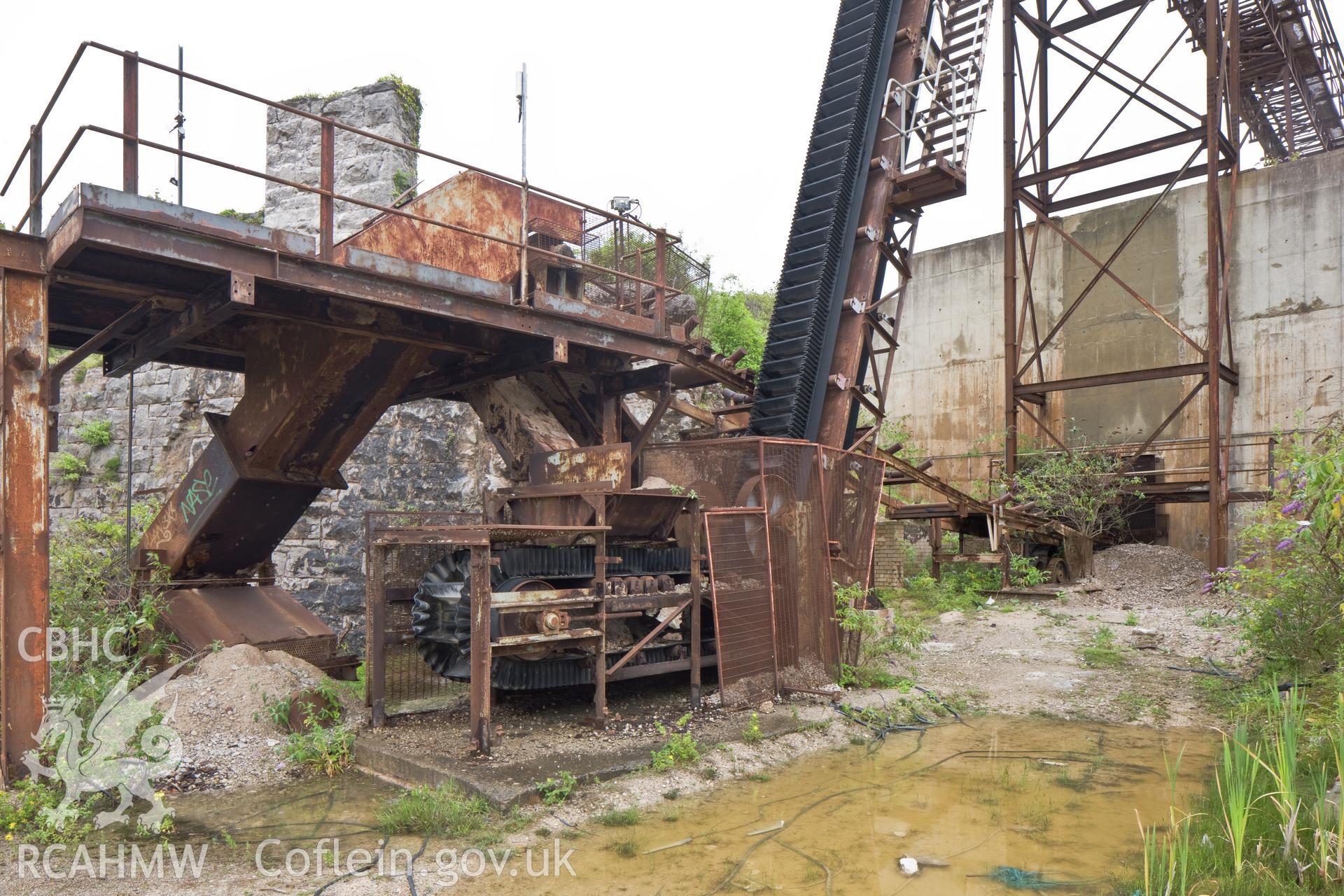 Close up of tunnel entrance with conveyor transfer in foreground.