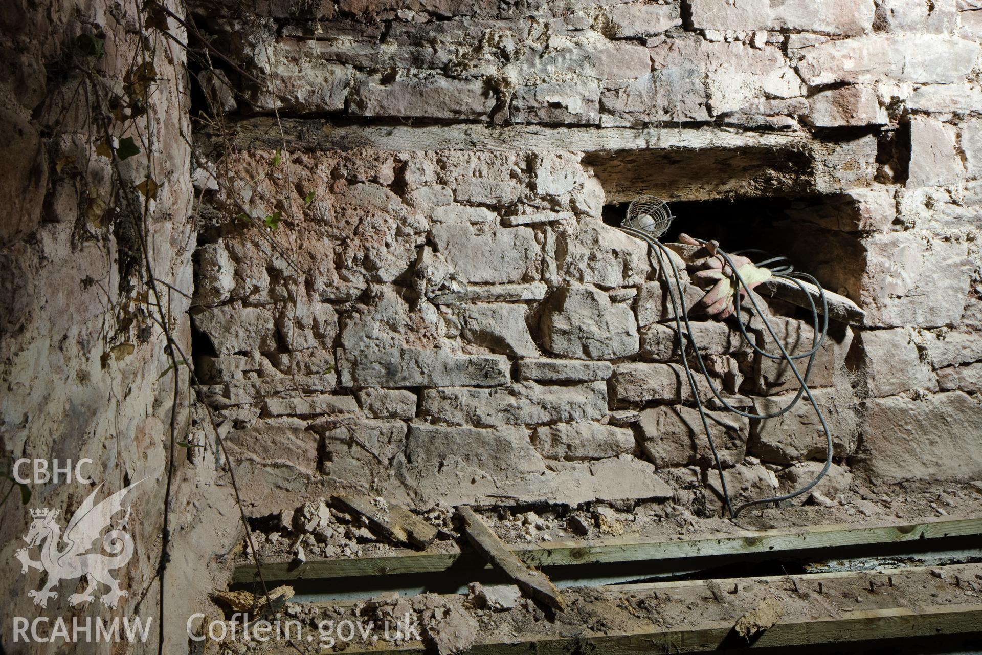 Blocked doorway in gable entrance to hall.