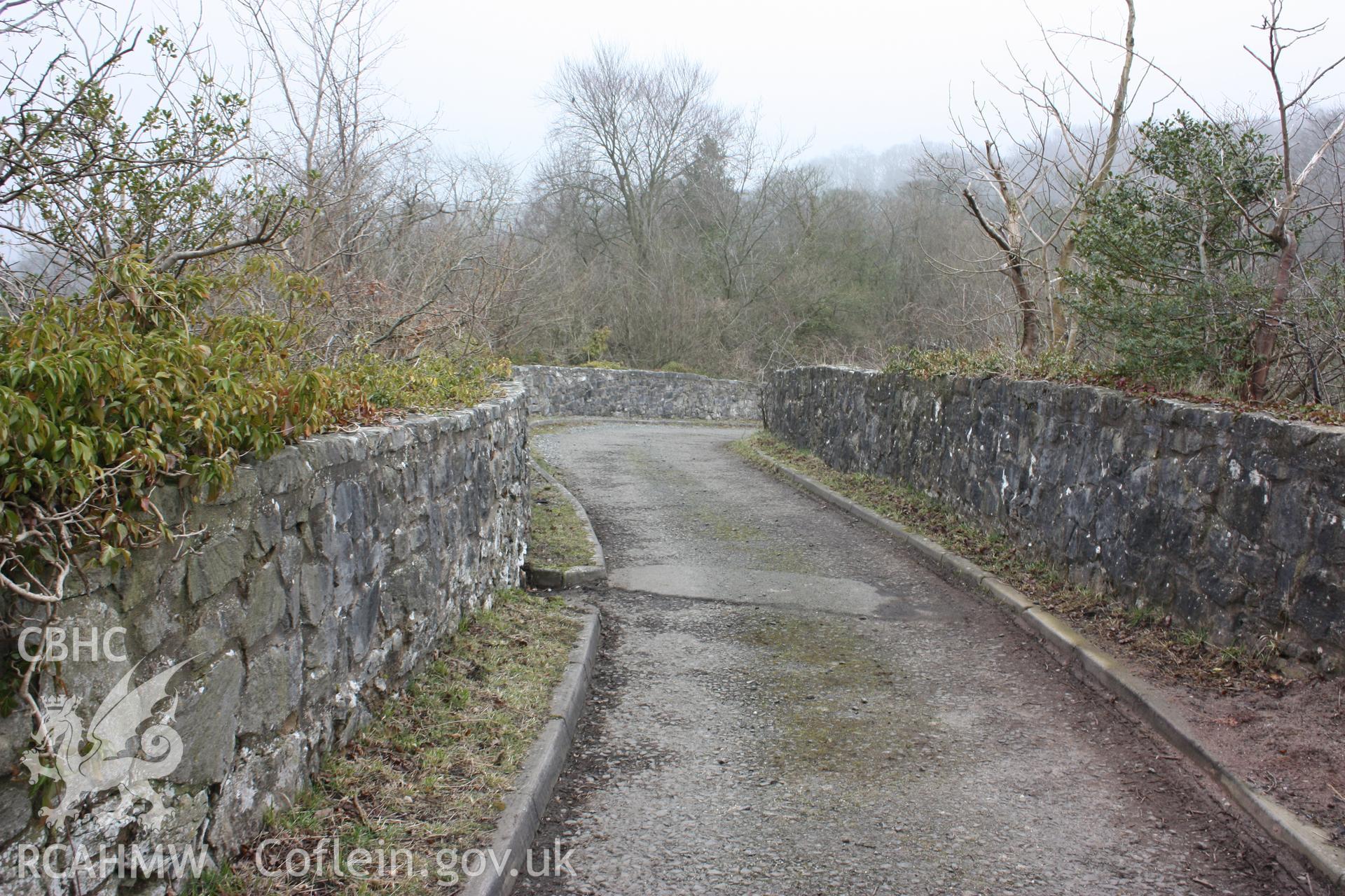 Road at Pen-y-graig, leading from former quarry offices into Froncysyllte village and ultimately to the Telford Road (modern A5). At this point, the road runs across the line of a former horse-drawn railway below.