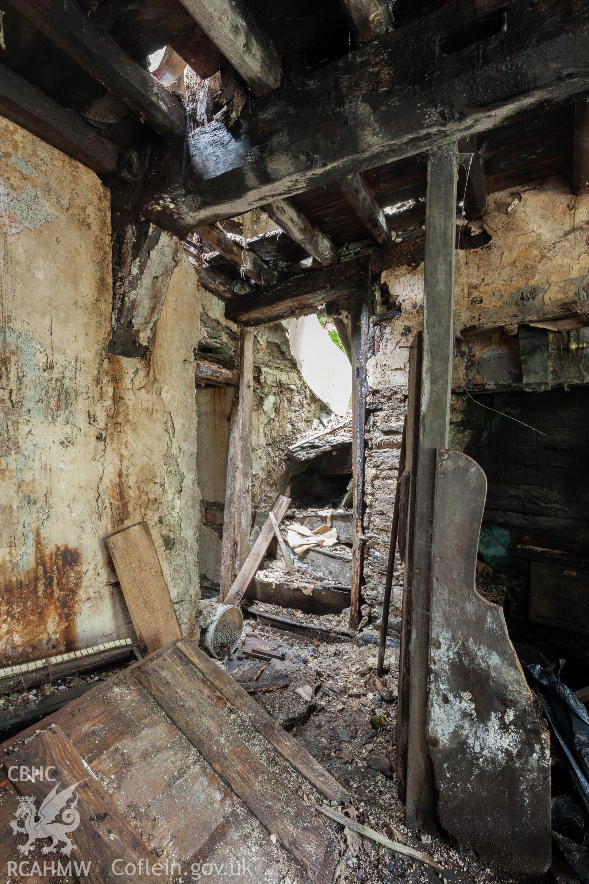Ground floor, passage to staircase to left of fireplace.