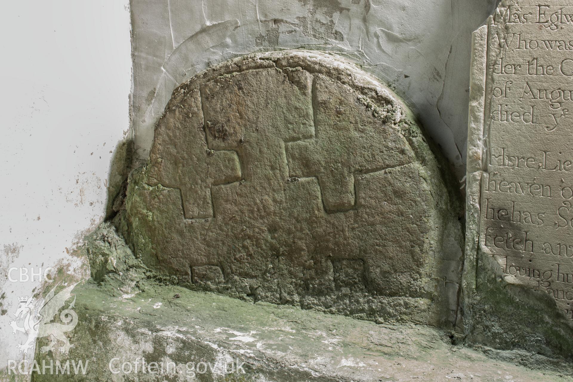 Head of carved cross in porch