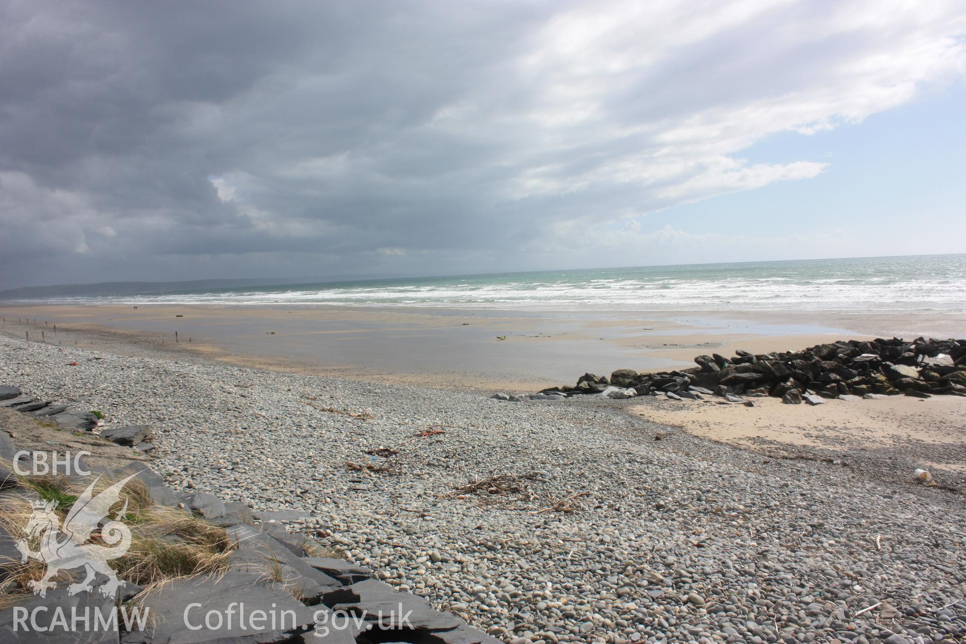 Tywyn beach looking south showing sparse distribution of tree roots system and peat deposits just to south of storm outfall
