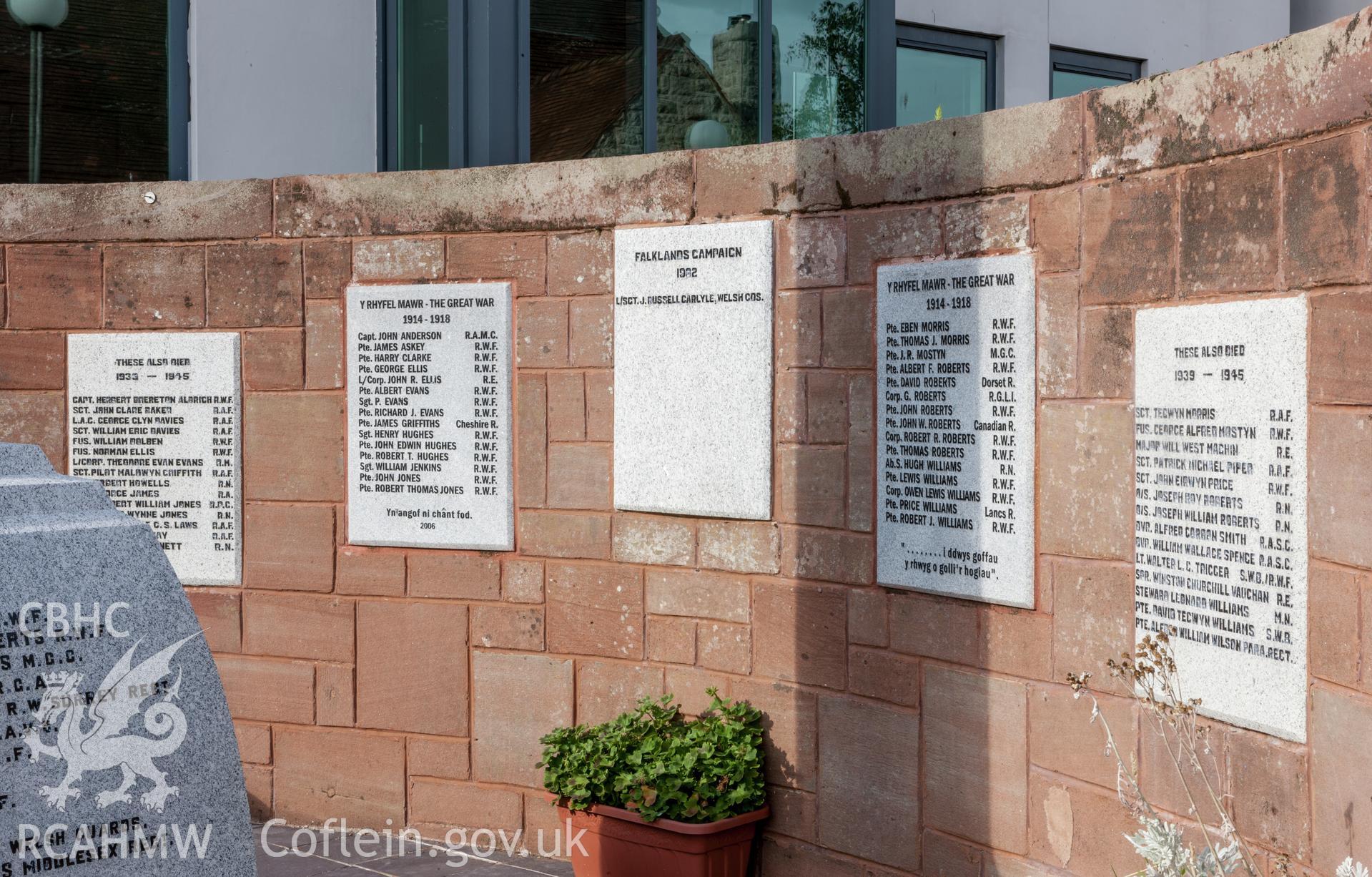 Lists of the dead on plaques around rear sandstone wall