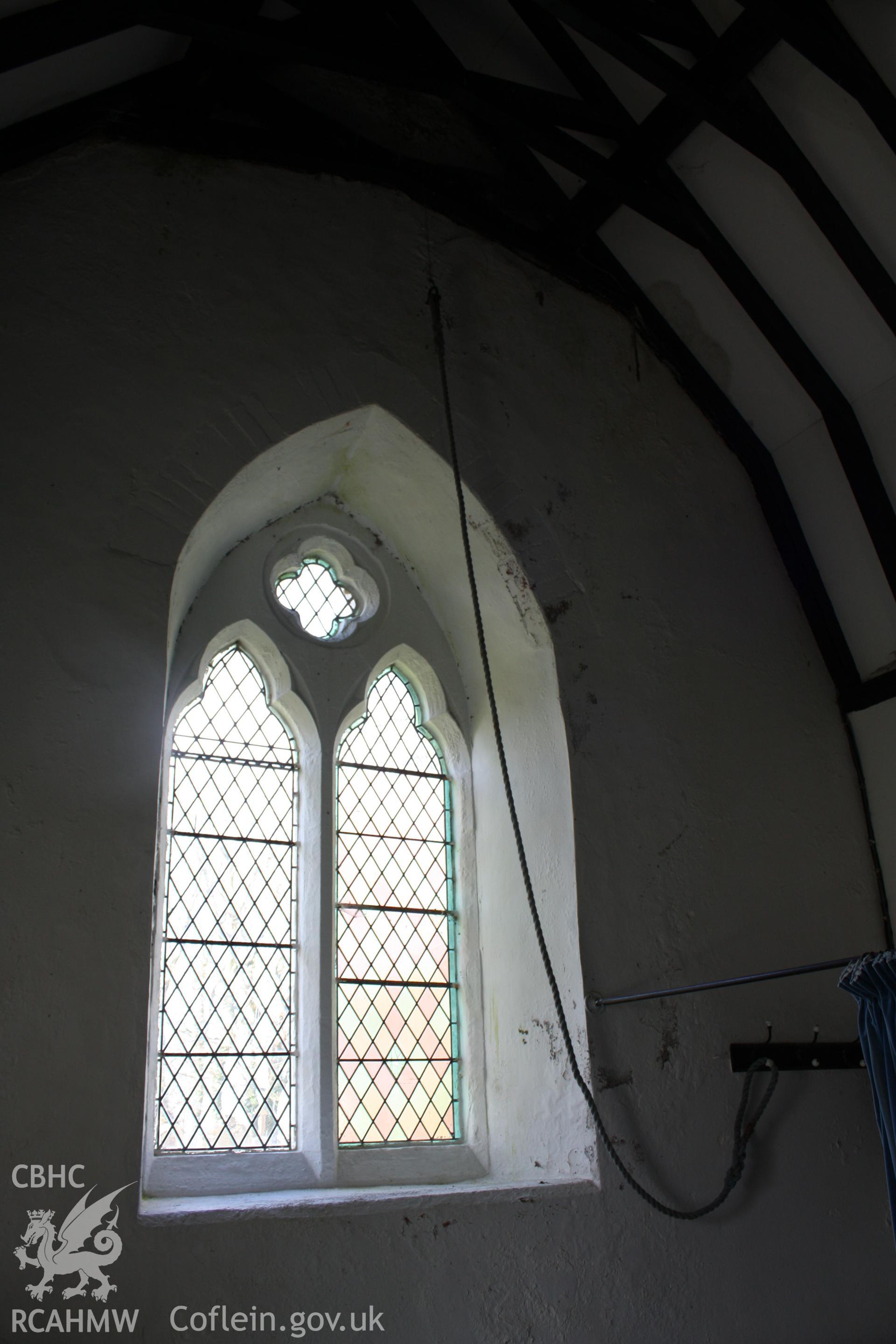 Detail of window in western wall with the rope linking to the bell mounted on the gable