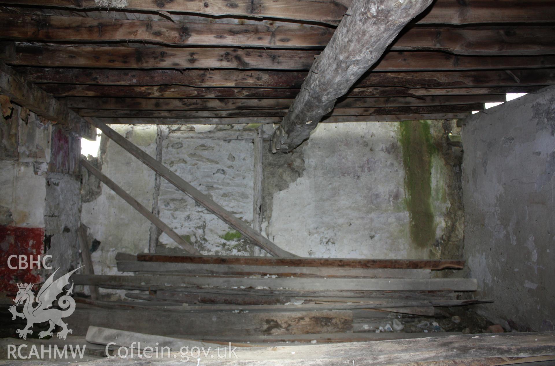 View showing blocked window, floor beam and joists