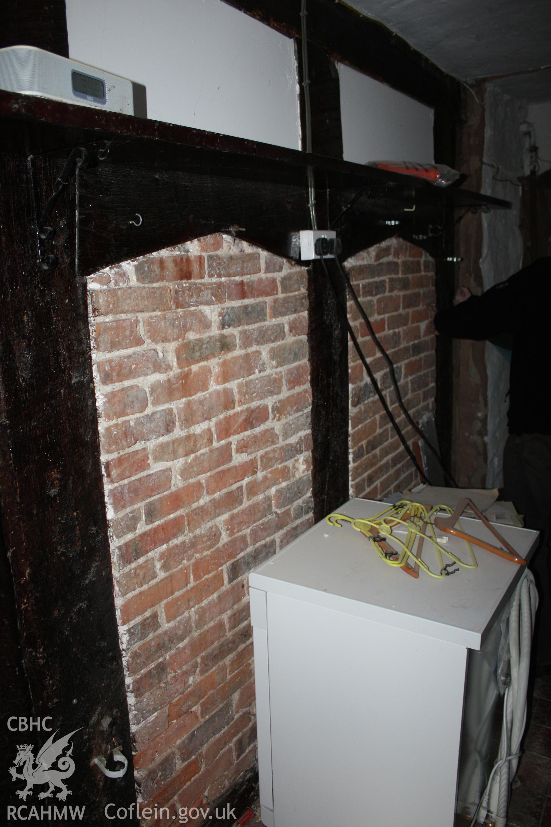 Internal; Oak post-and-panel partition with two doorways, each with a four-centred head.