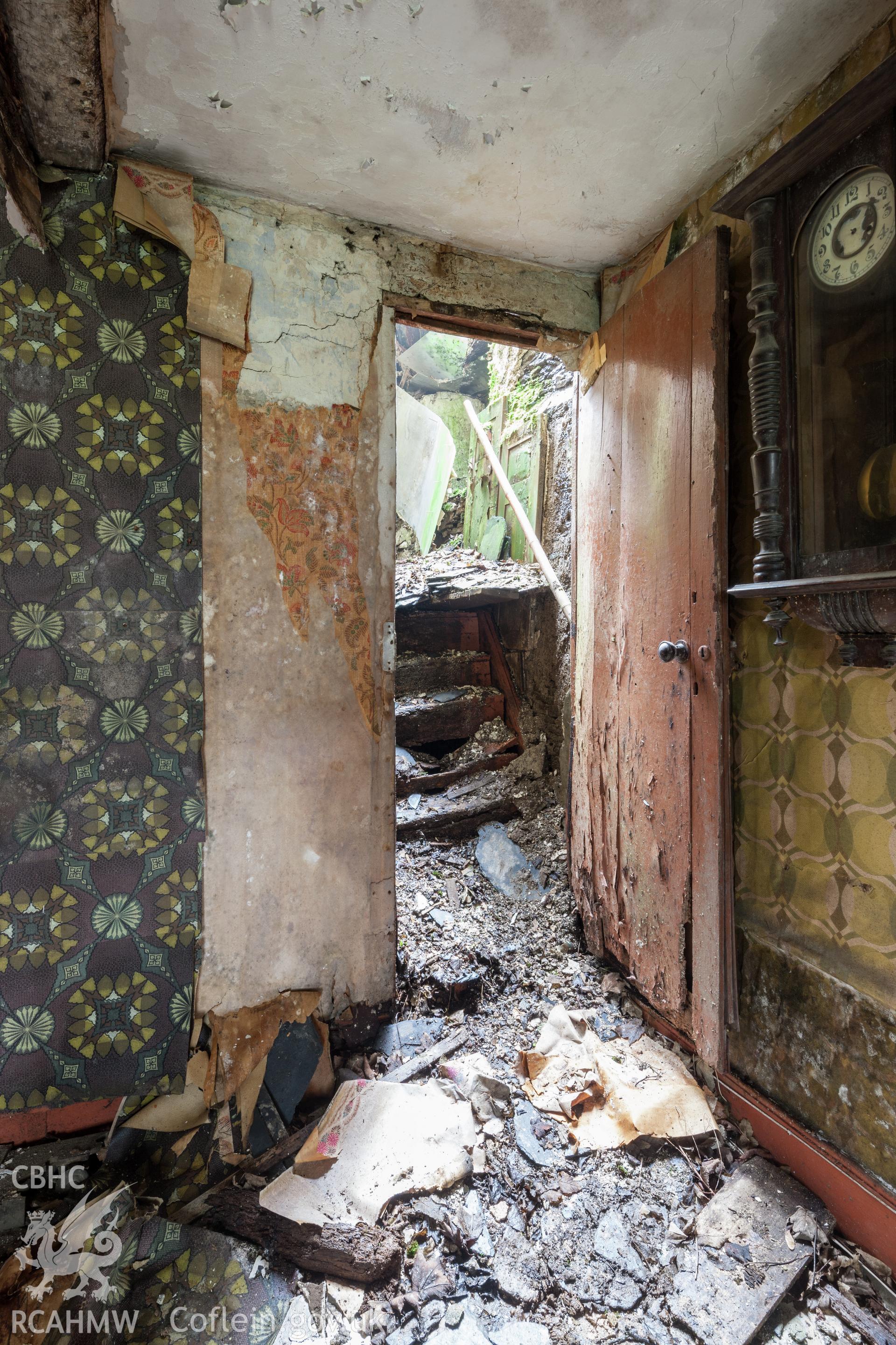 Doorway leading to staircase on the southwest of the fireplace block.