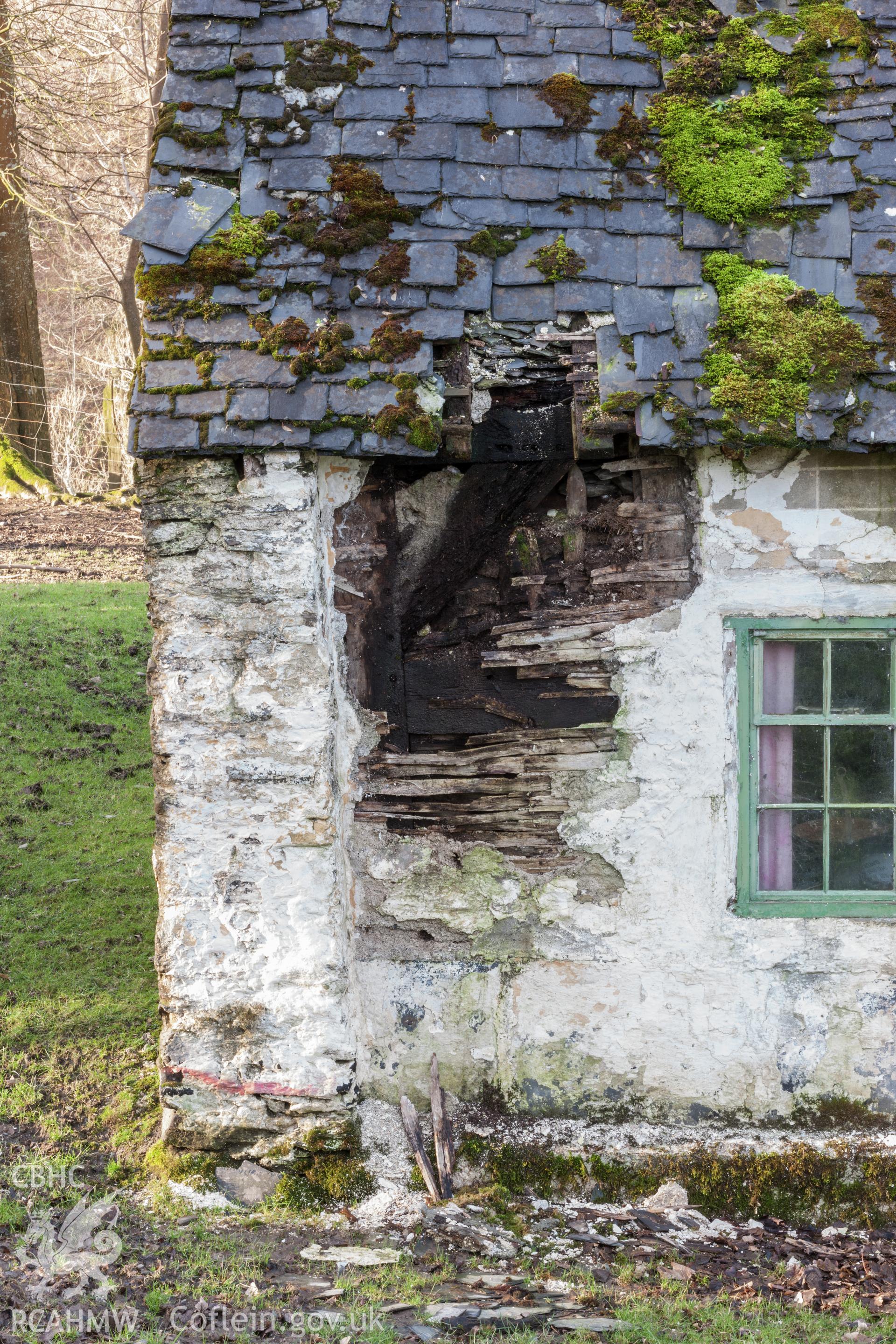 Timber frame embedded in wall in east corner