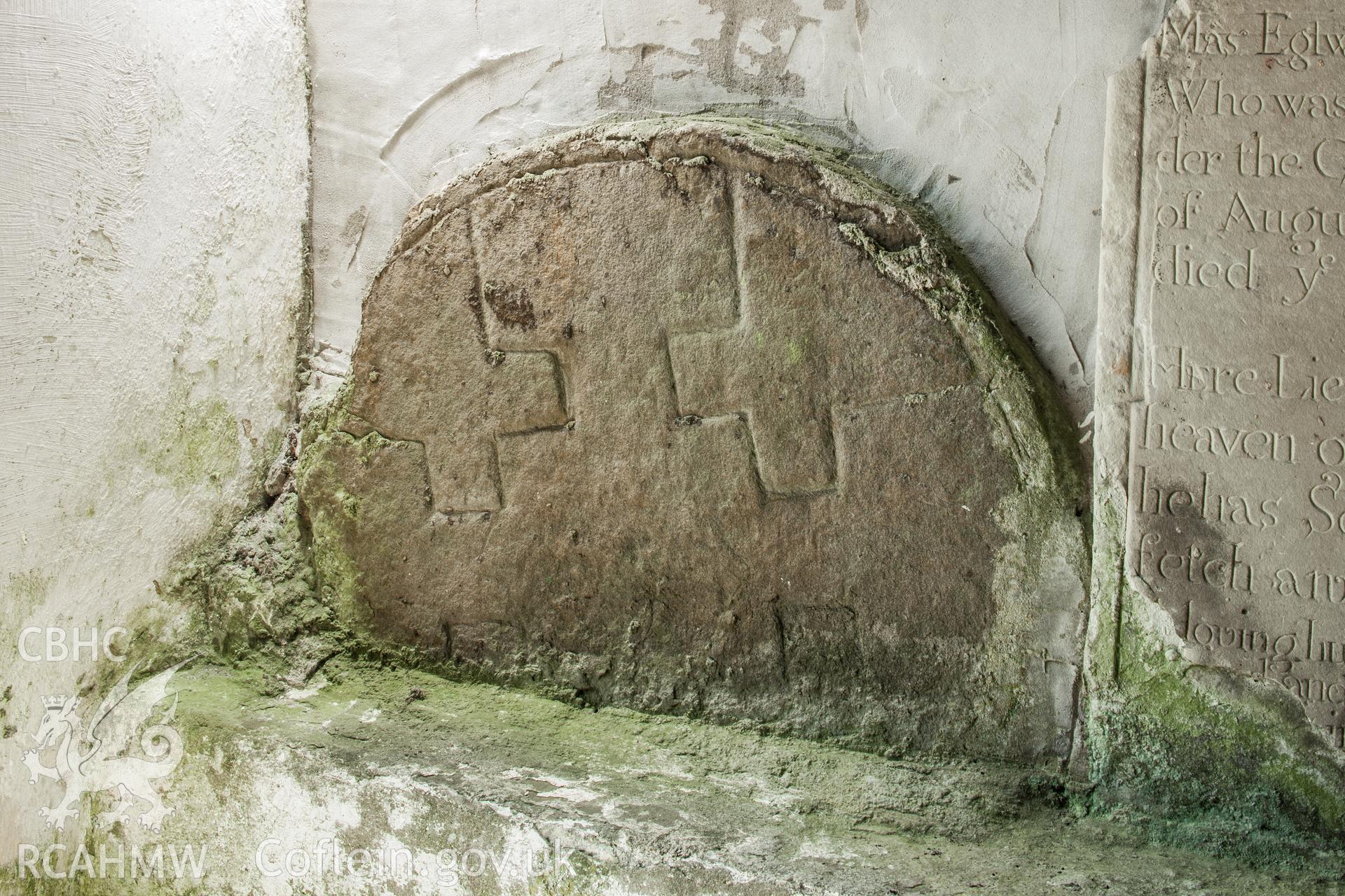 Head of carved cross in porch