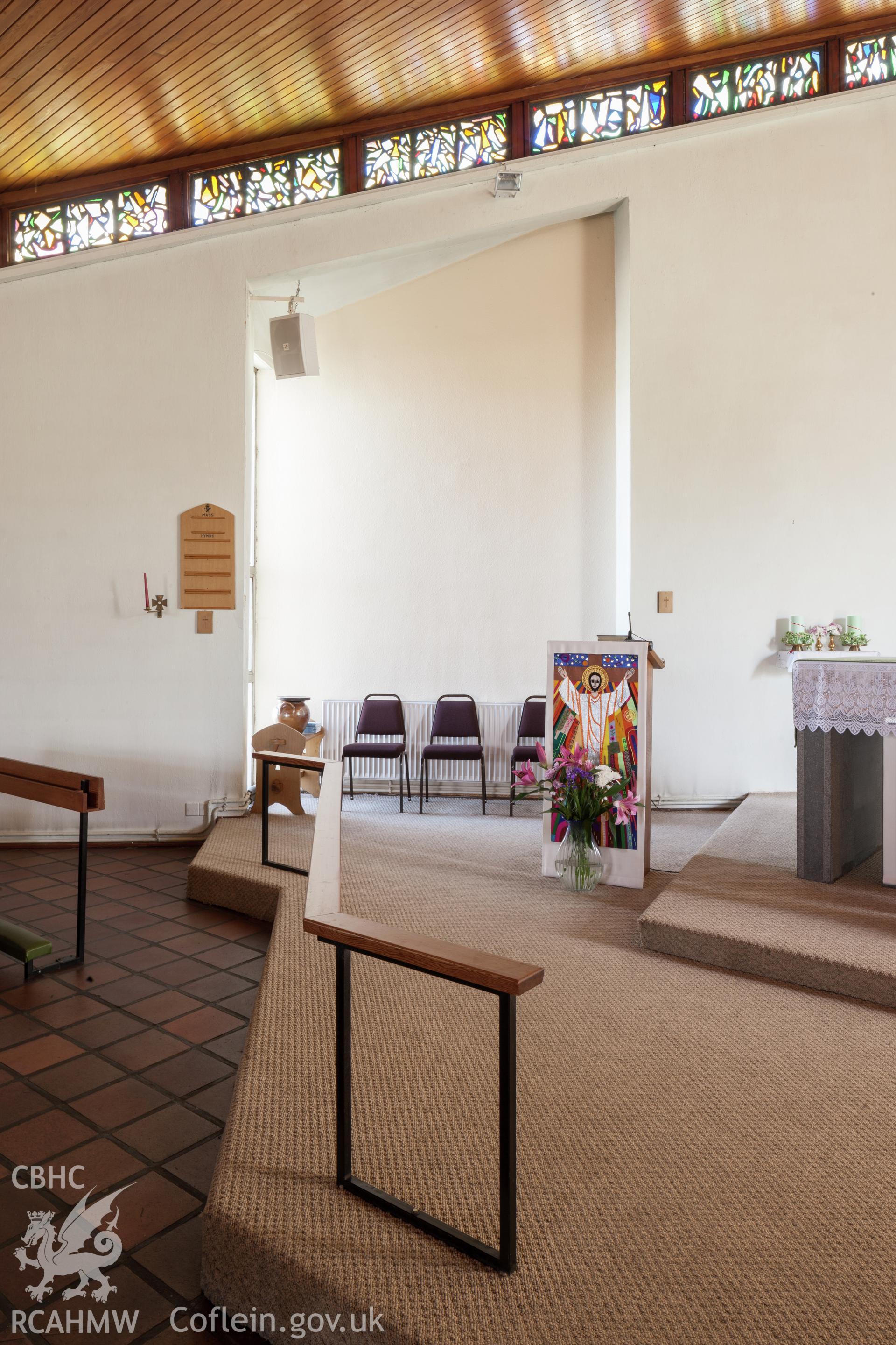 Recessed windows and marginal stained glass on southeast wall.