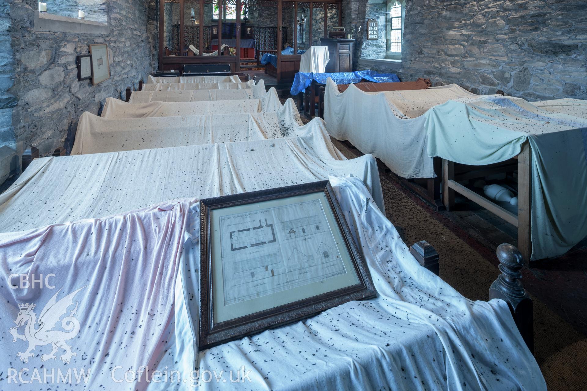 Pews with protective sheets, covered in bat droppings