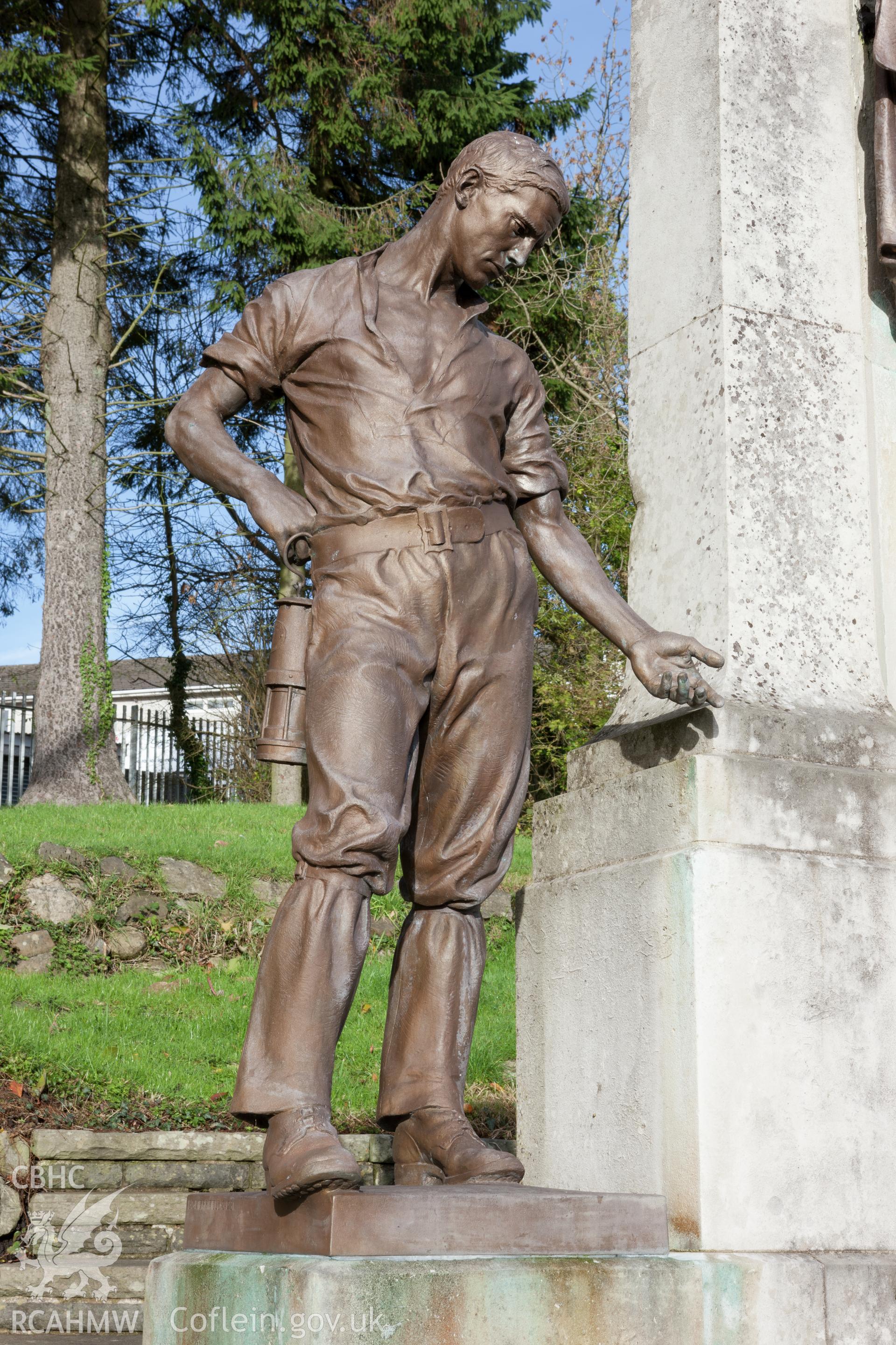 Detail of left hand figure of miner