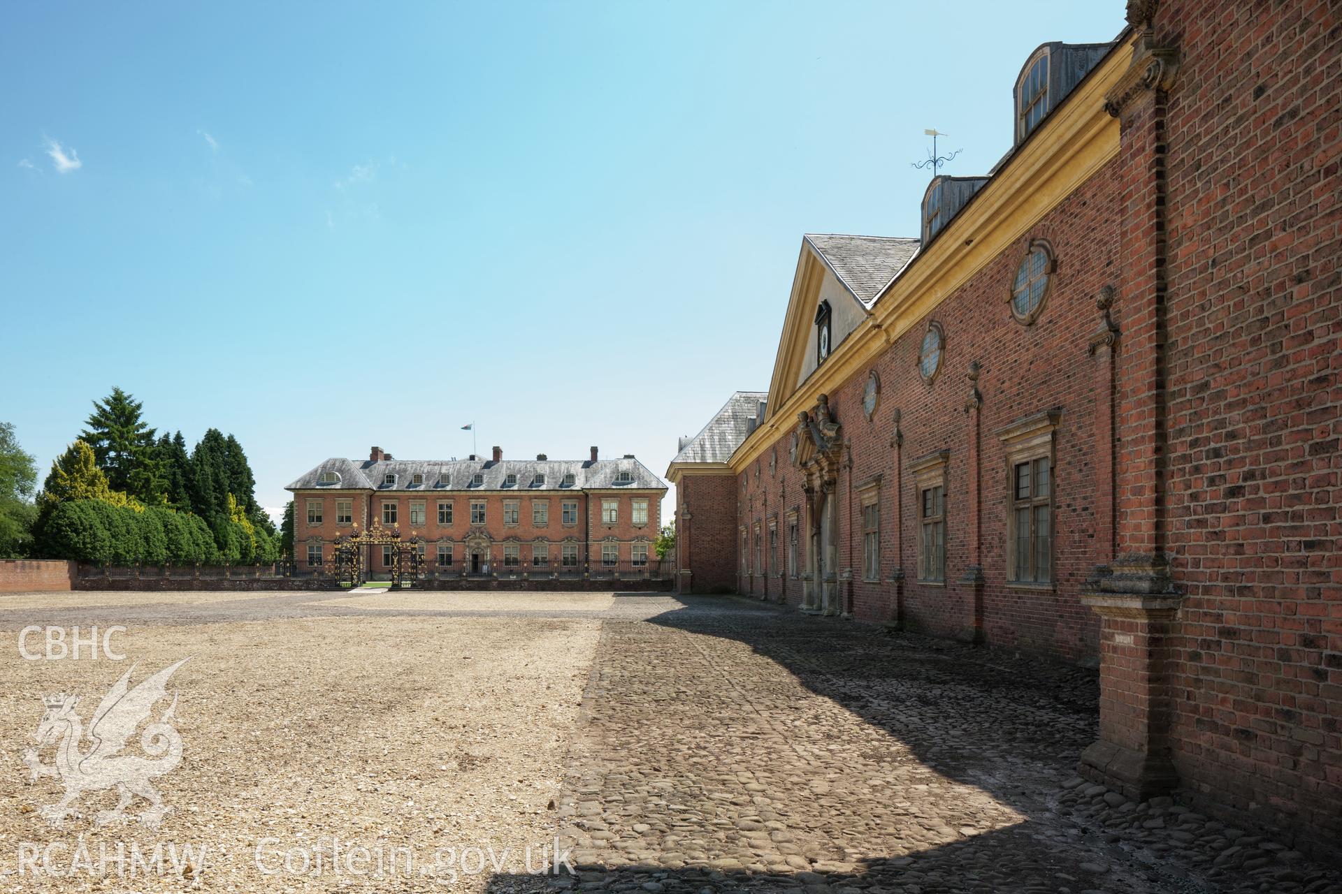 Oblique view of stable with main house, from the northwest