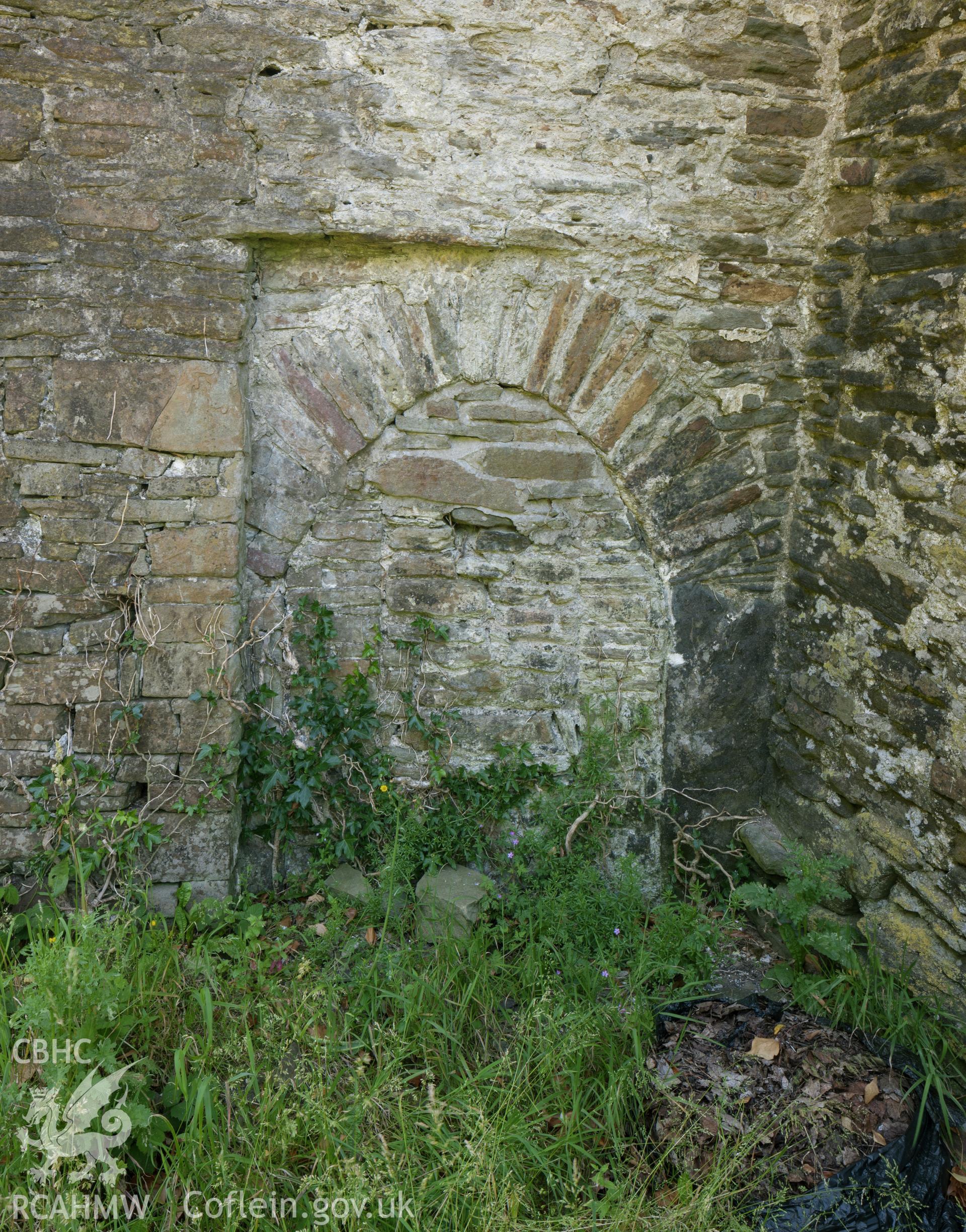 Blocked doorway behind tower in west wall