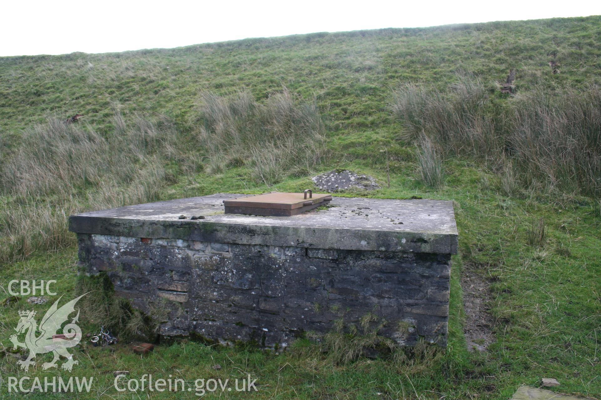 Digital image of Rhaslas Pond and the surrounding area: View  of the filter house from the base of the dam.