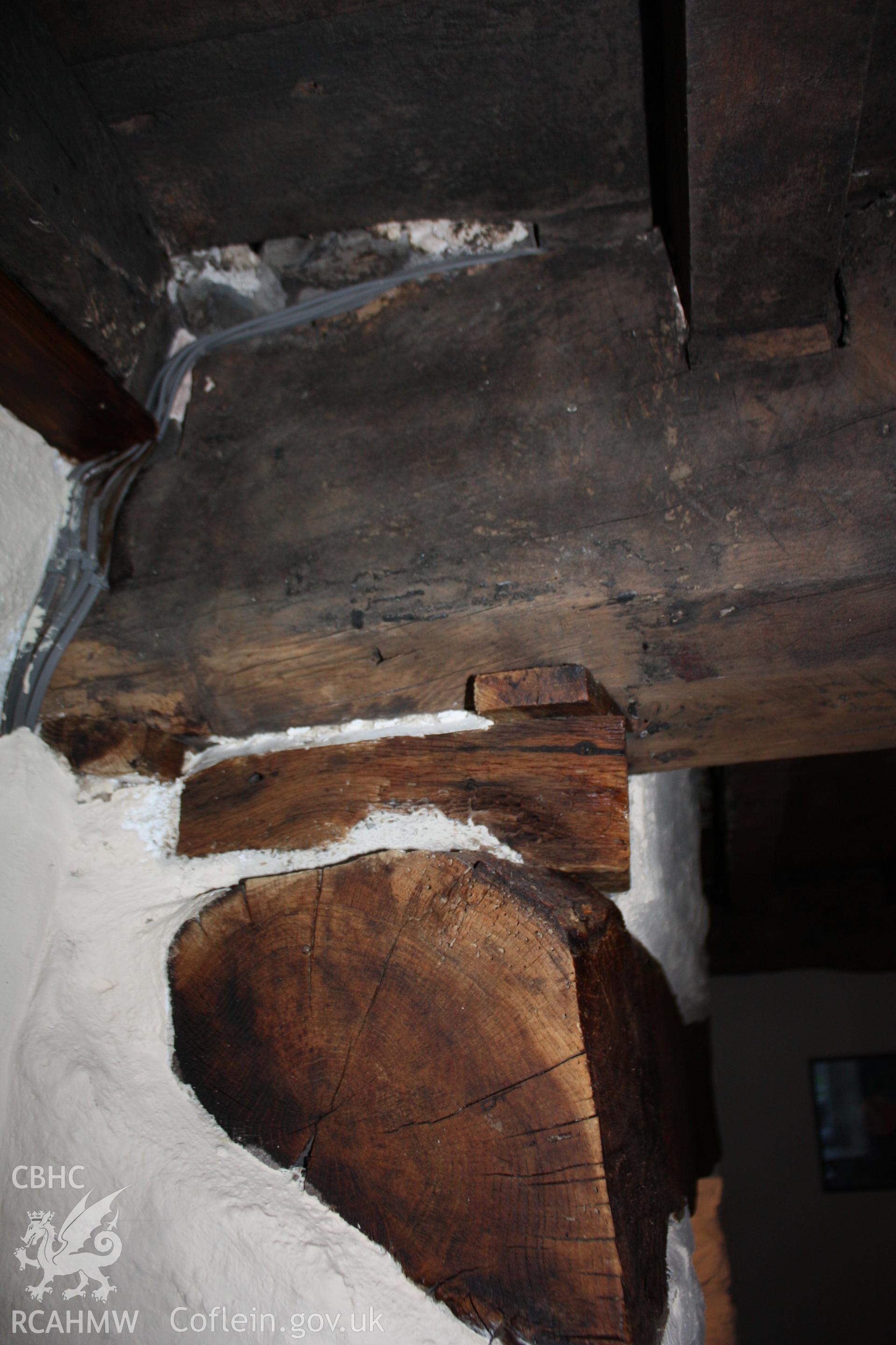Parlour/living-room ceiling-beam stop over fireplace lintel.
