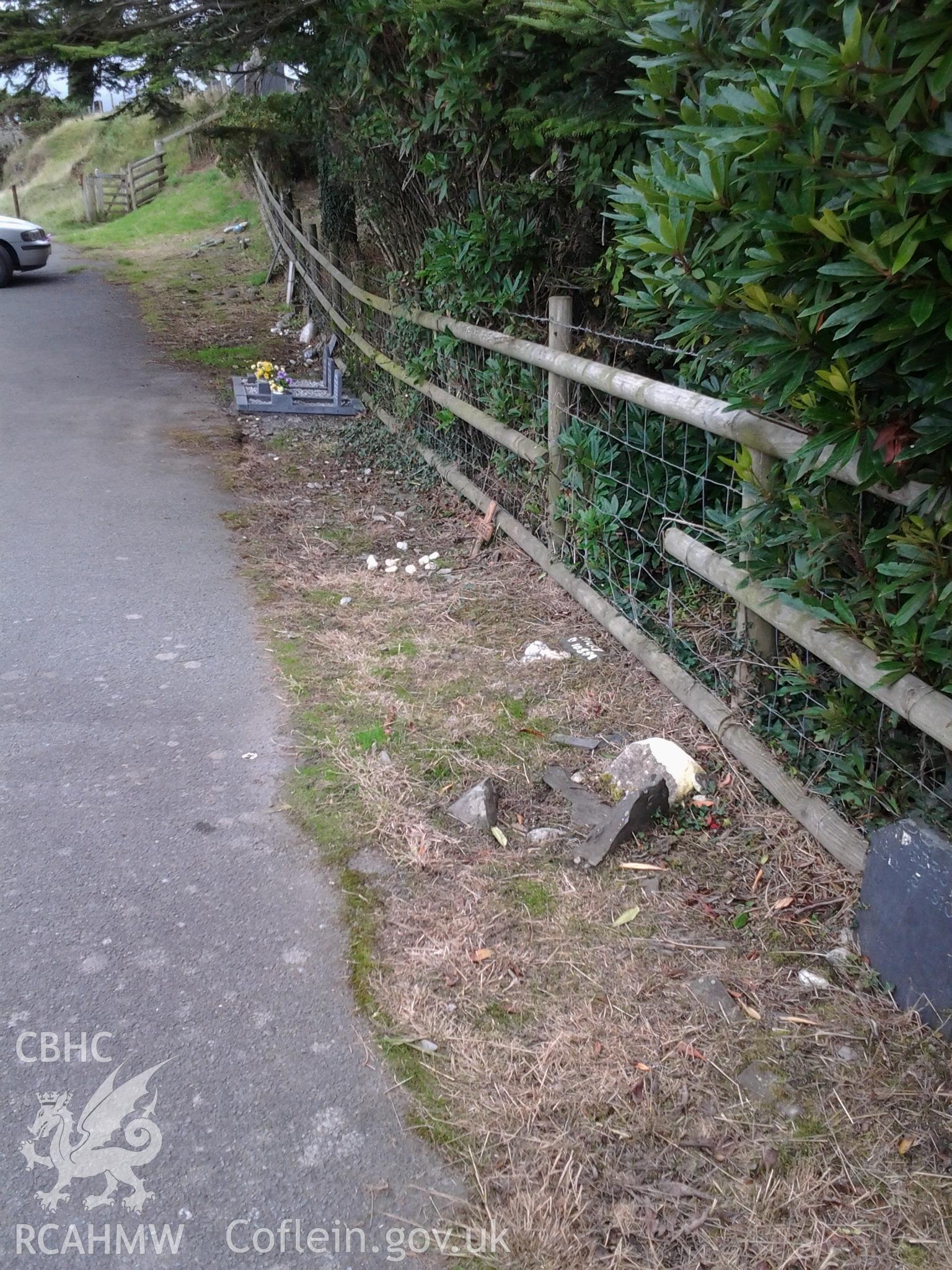 Small memorials to family pets laid alongside the fence of the churchyard