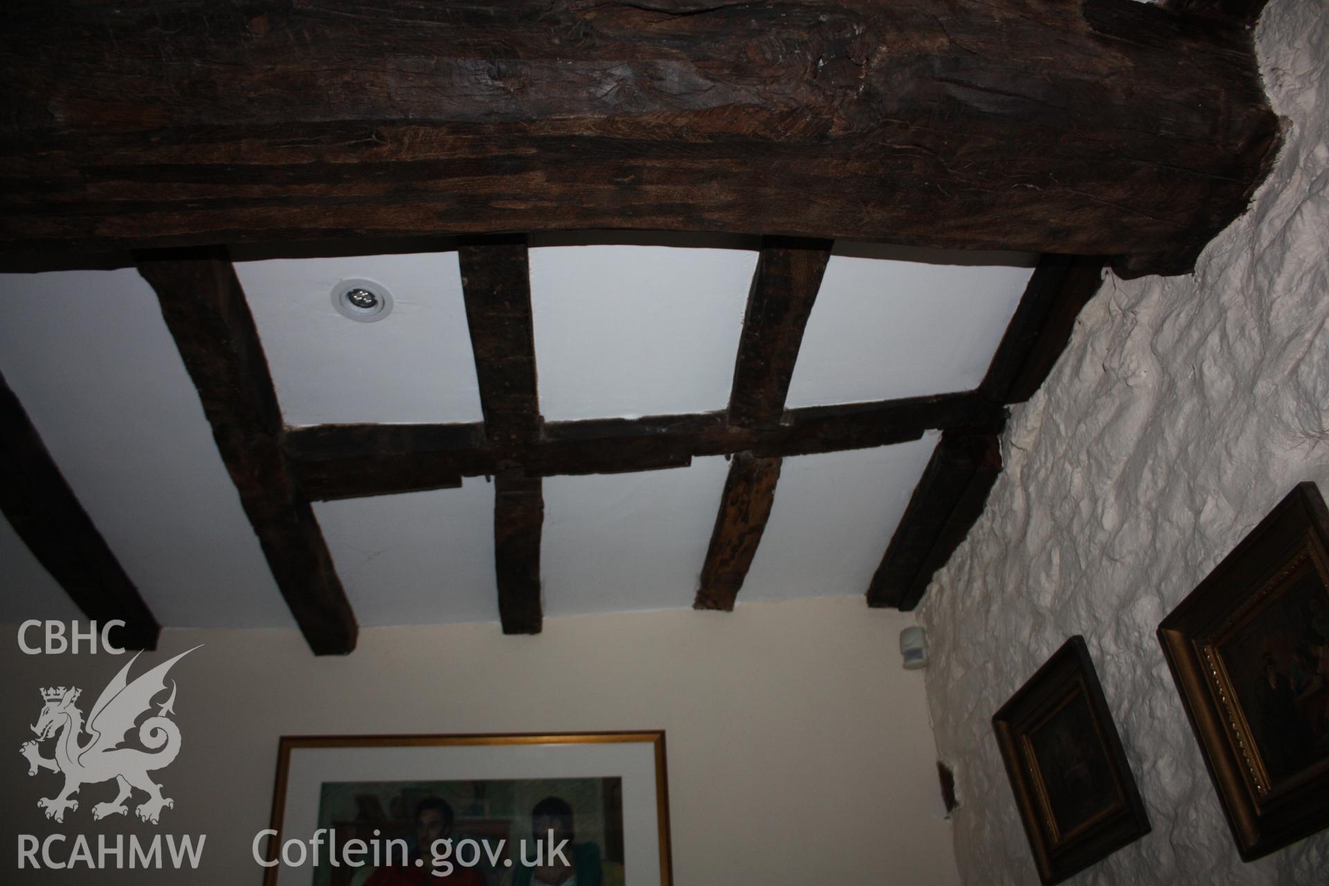 Cross-wing rear parlour showing ceiling-beams and line of partition/site of stair