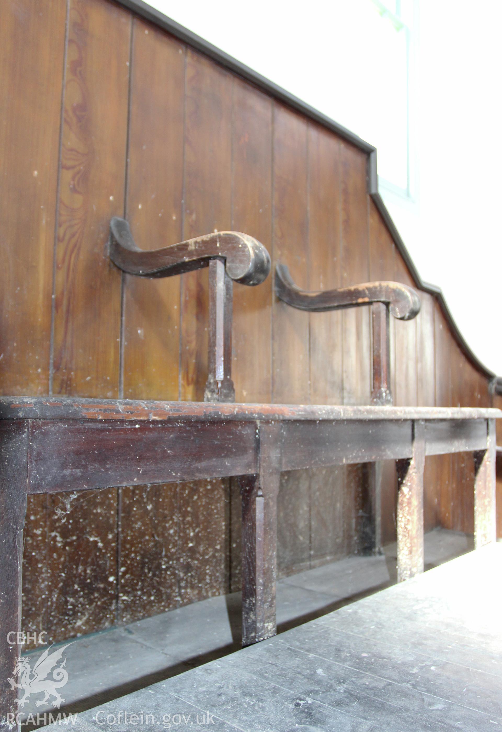 Detail of Pew seating against east wall at gallery level