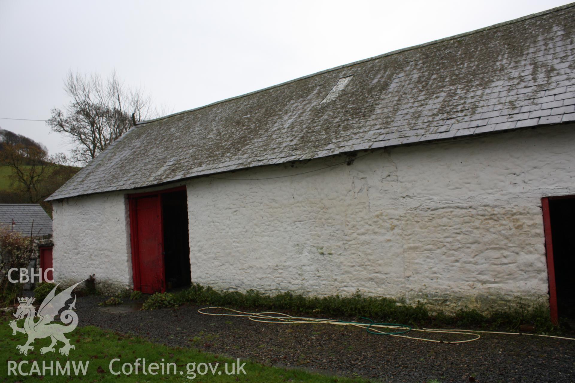 Exterior, view of stable/cow-house doorway & former hay-shed doorway in north-east elevation.