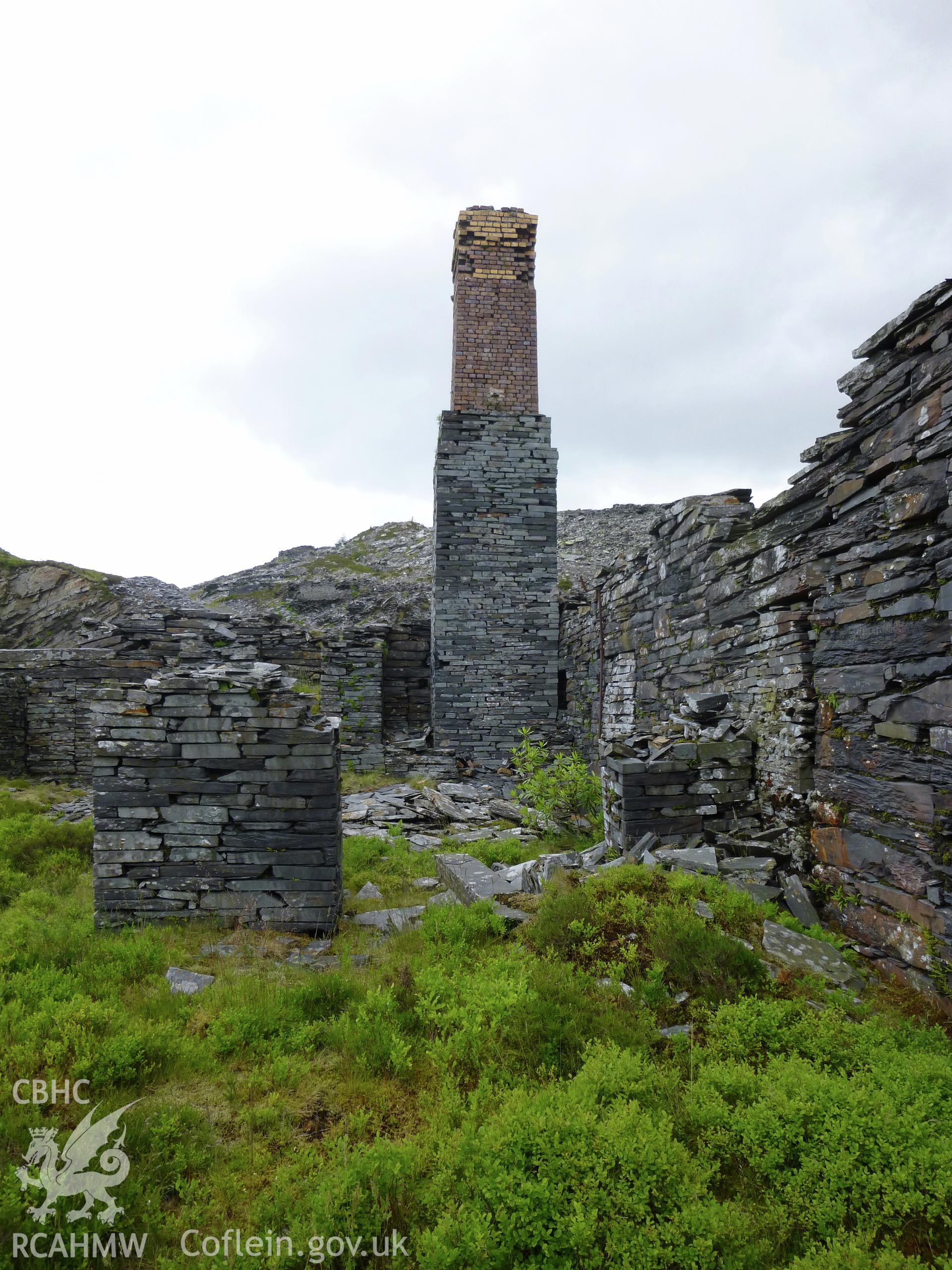 View looking west at the engine house chimney and building attached to the north side of the mill.