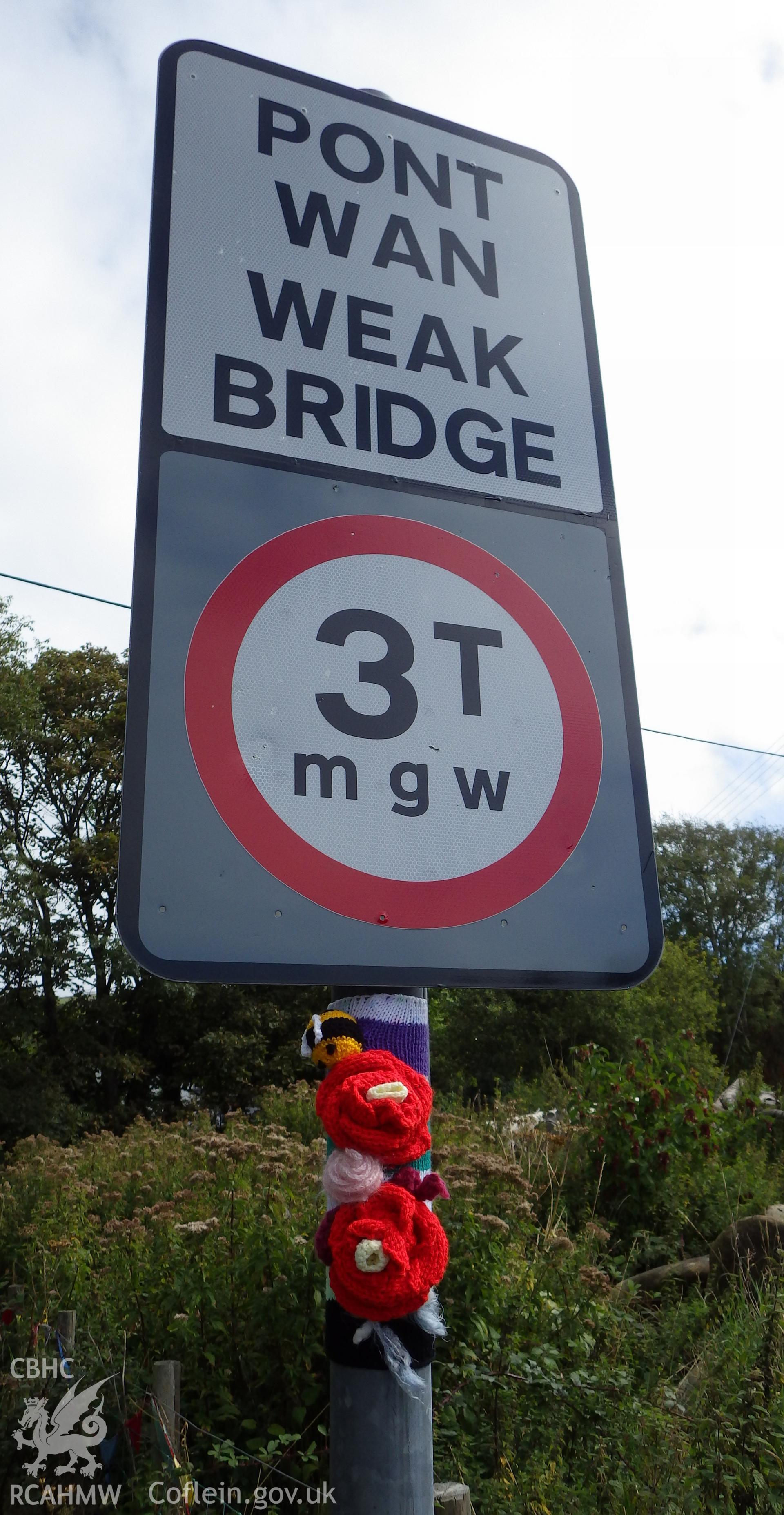 Weak bridge sign with flowers and ladybird