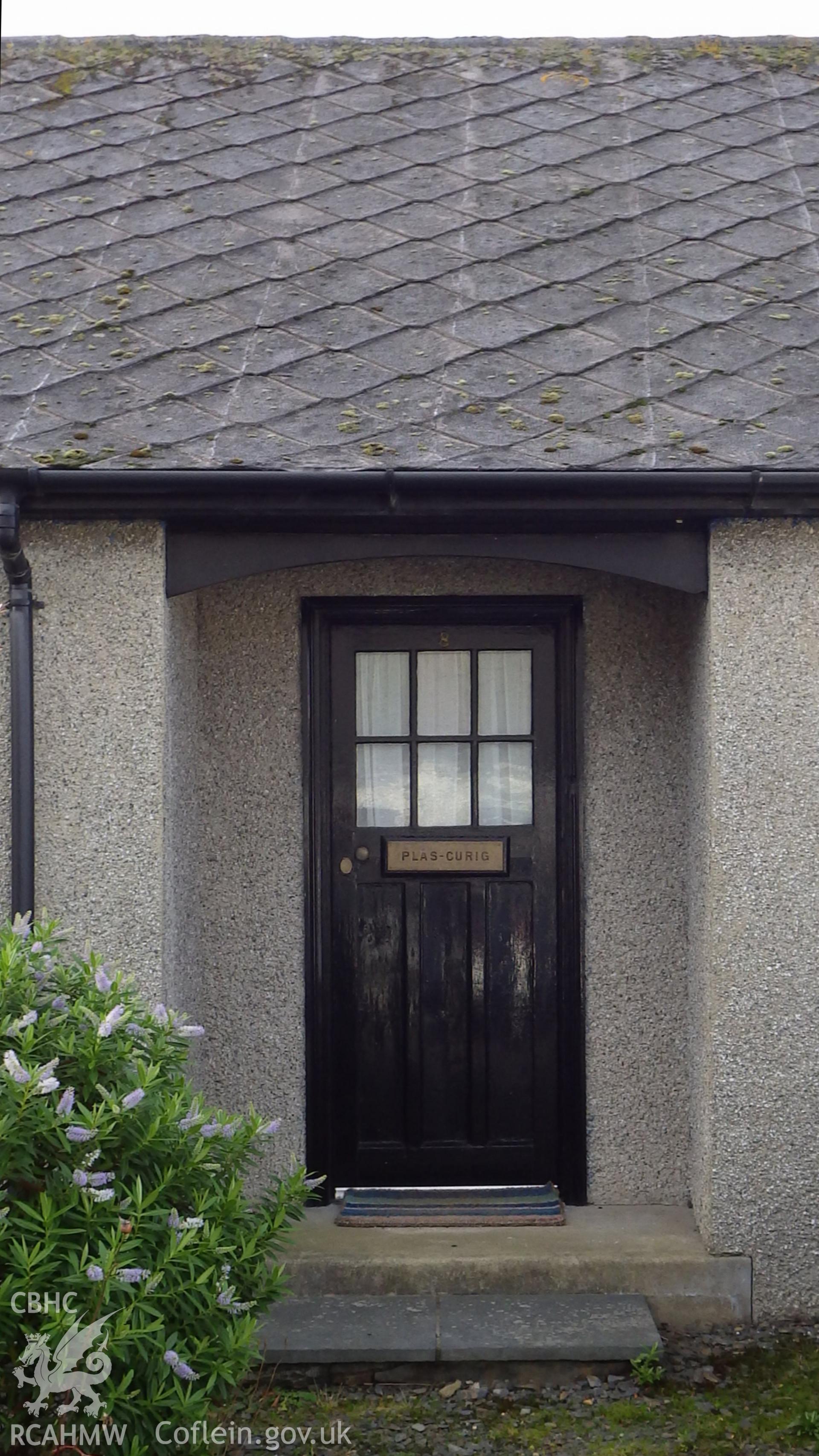 Detail of front door and rendered exterior