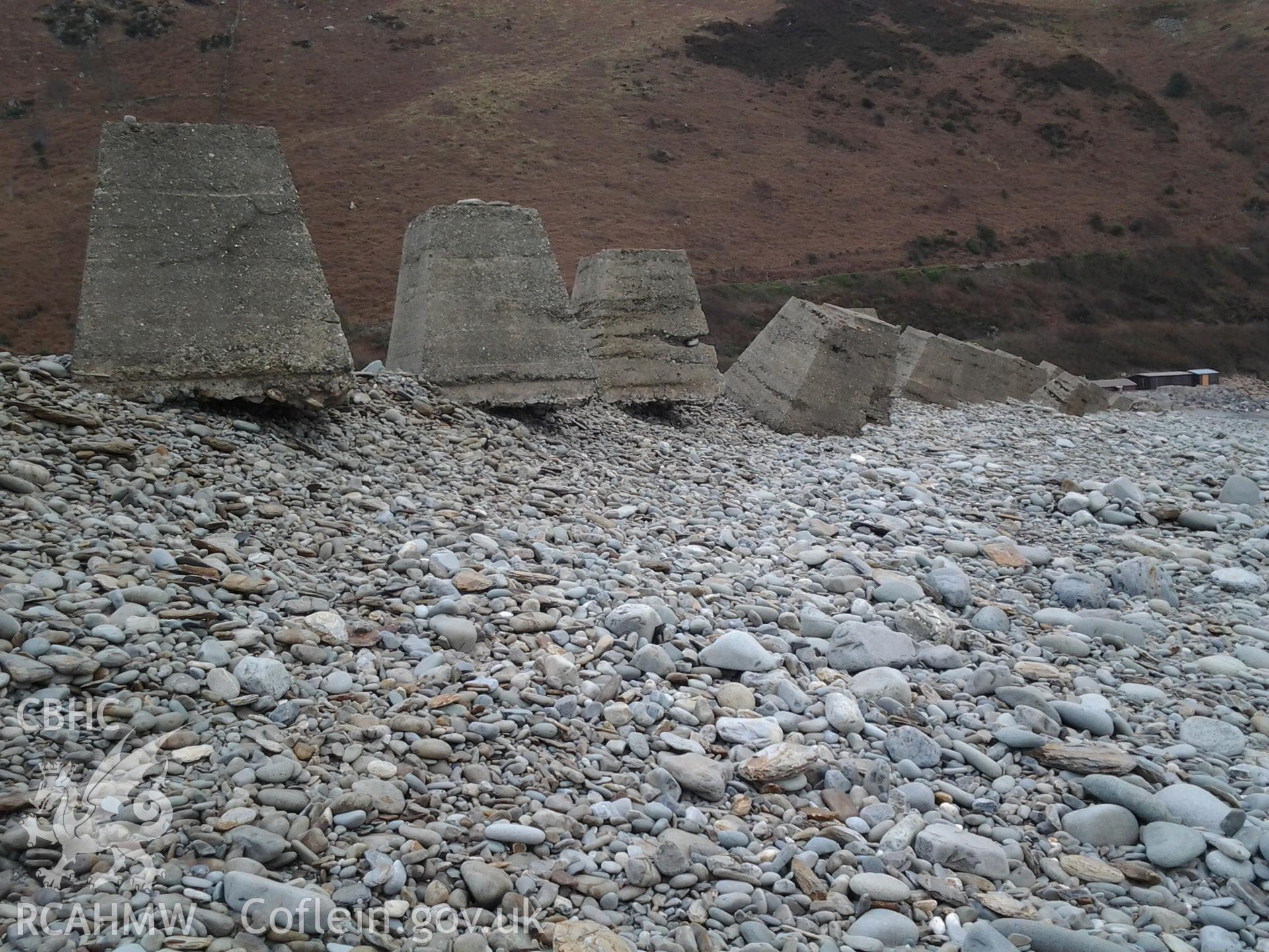Blocks undercut by wave action and changes in profile of the shingle ridge causing toppling