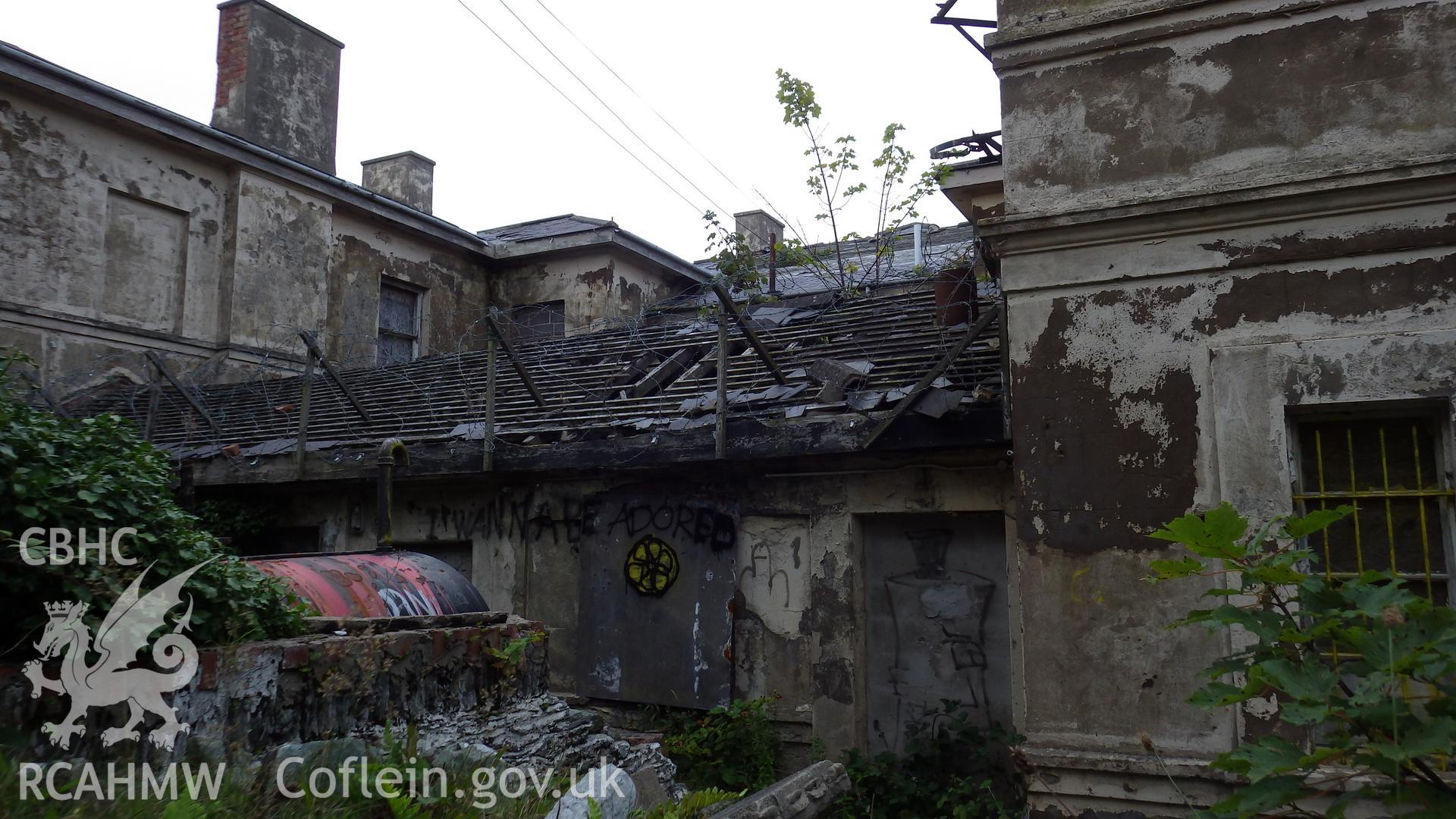 View of the damaged infill extension between the two wings from the road