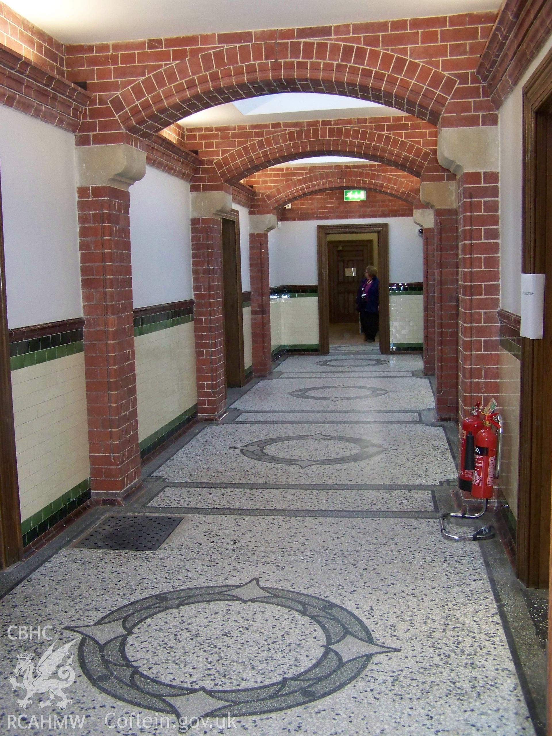 Interior corridor showing tiling to walls and fall, and brick arches