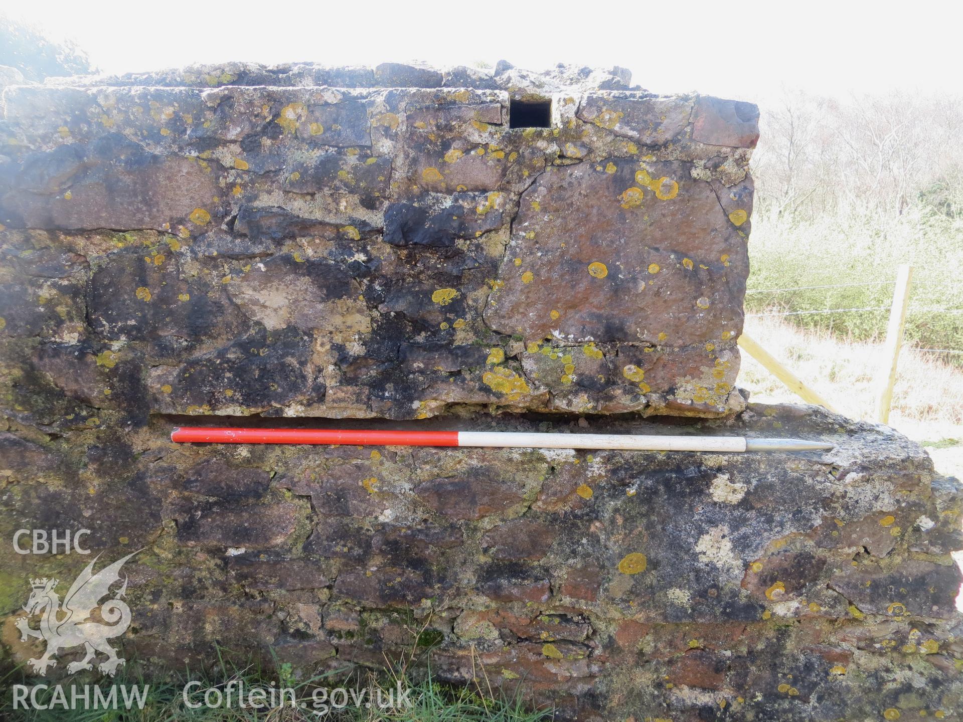 Close-up view of slot detail in hut wall; 1m scale.