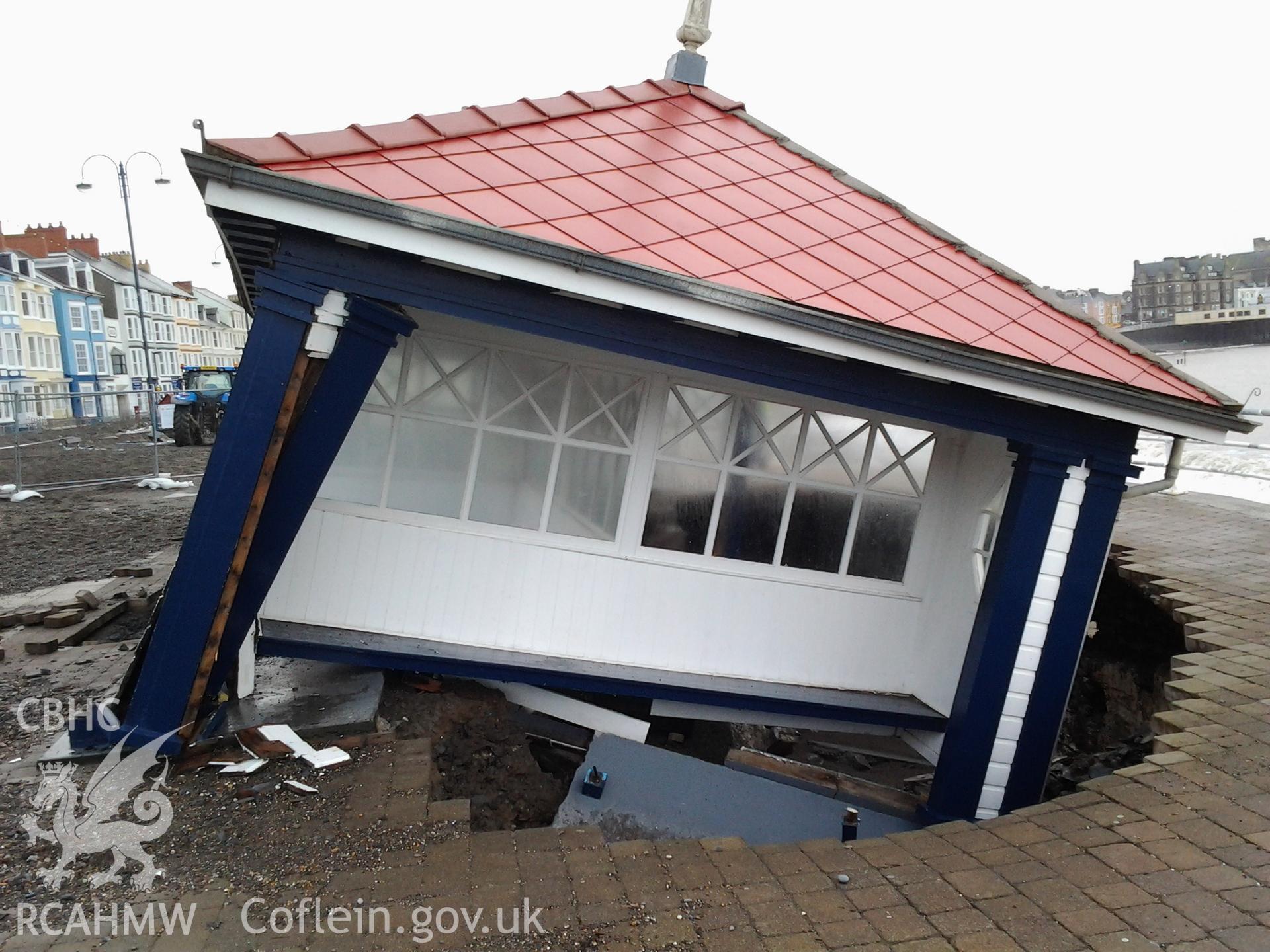 Northern end of collapsed seafront shelter undermined by a breech of the seawall