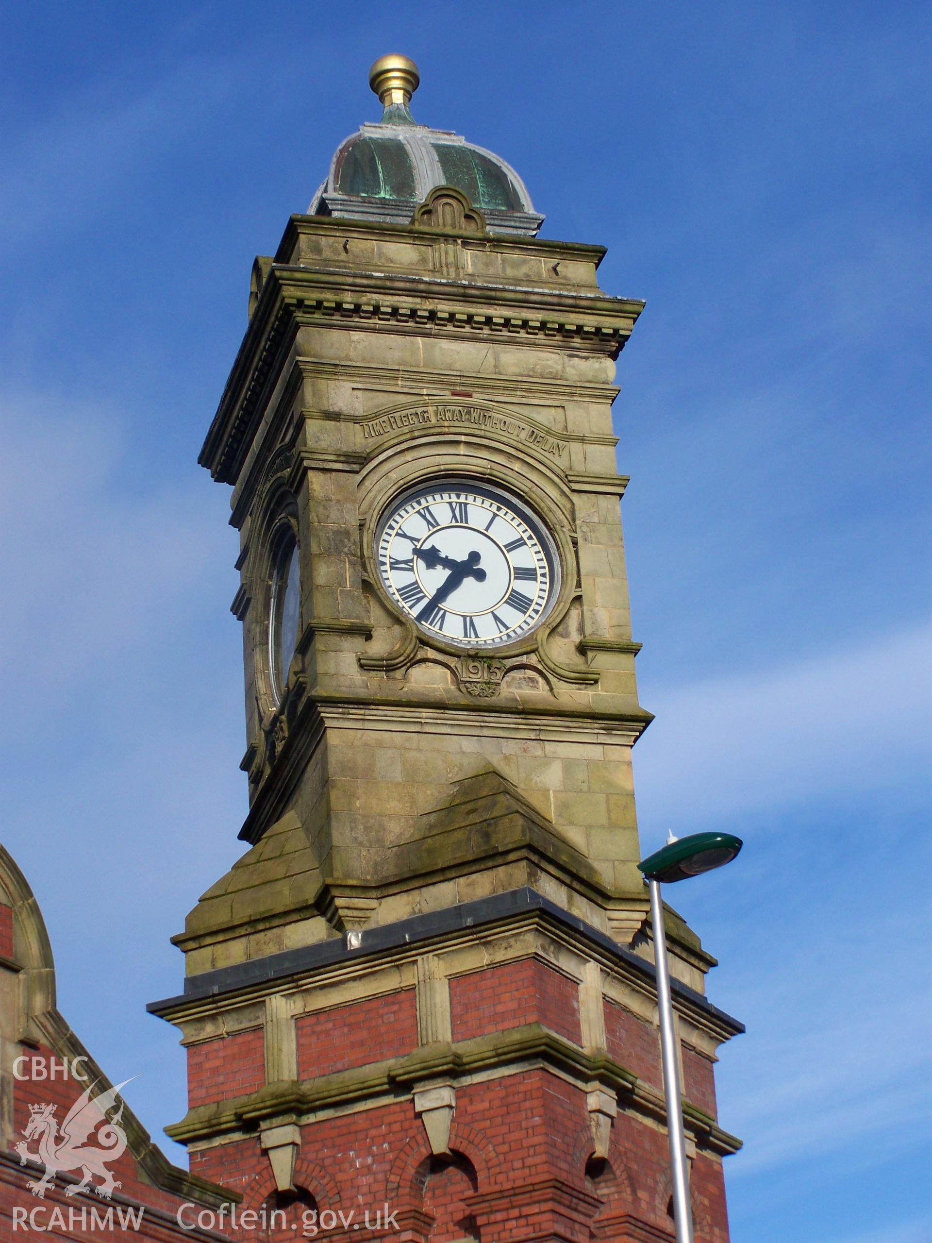 Close up of face of clock with motto 'Time Fleeth Away Without Delay'
