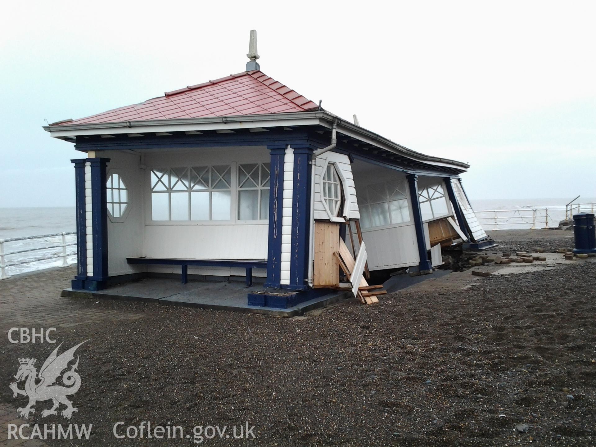 Northern end of collapsed seafront shelter undermined by a breech of the seawall