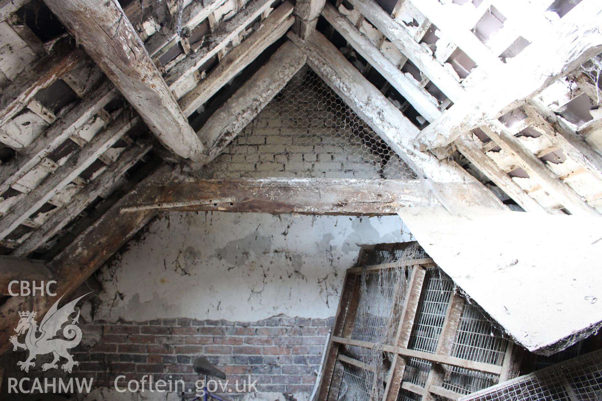 Interior; truss with collar, double purlins and ridge. Brick blocked end wall represents later division between domestic and barn units.