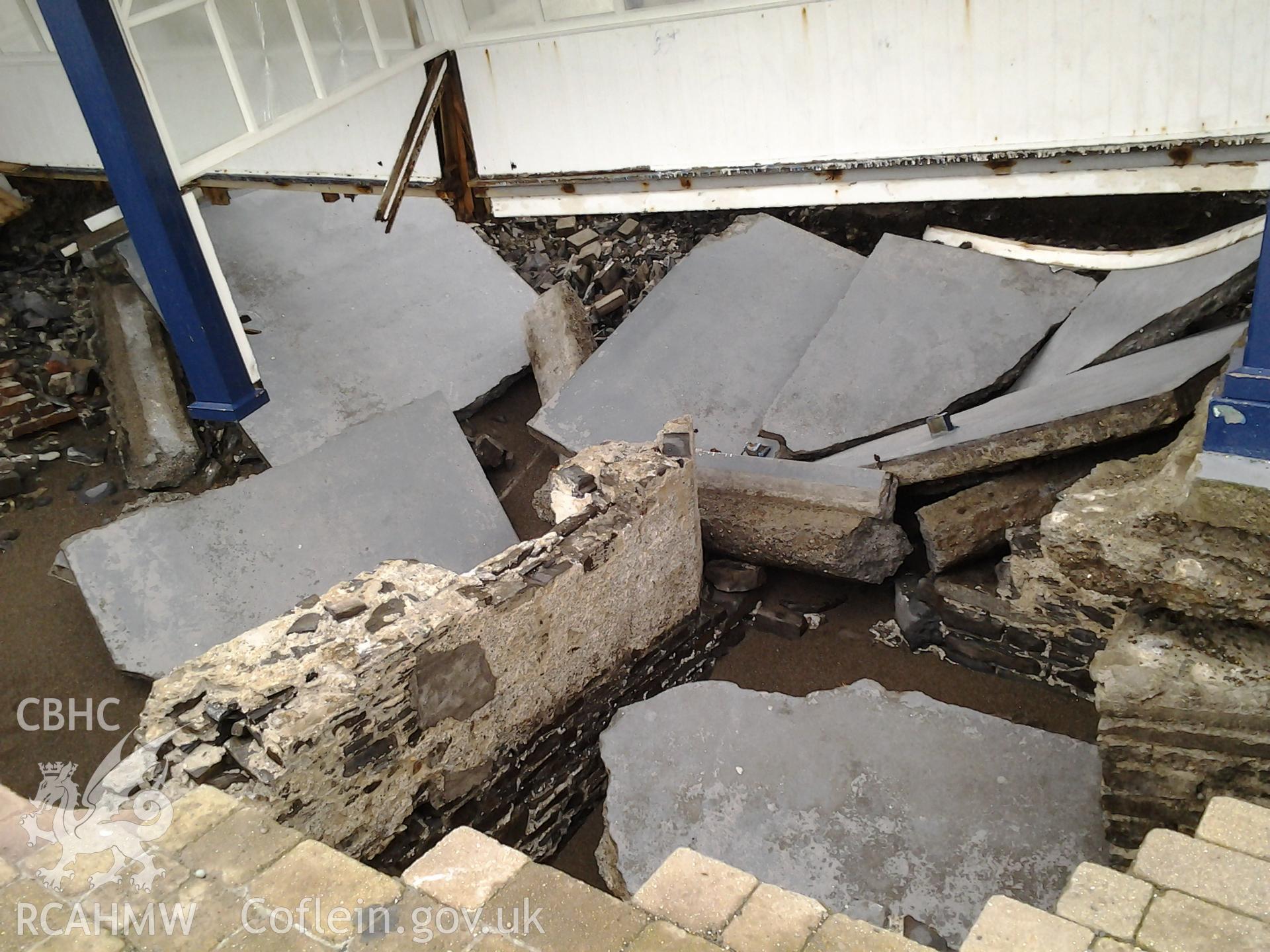 Northern end of collapsed seafront shelter undermined by a breech of the seawall