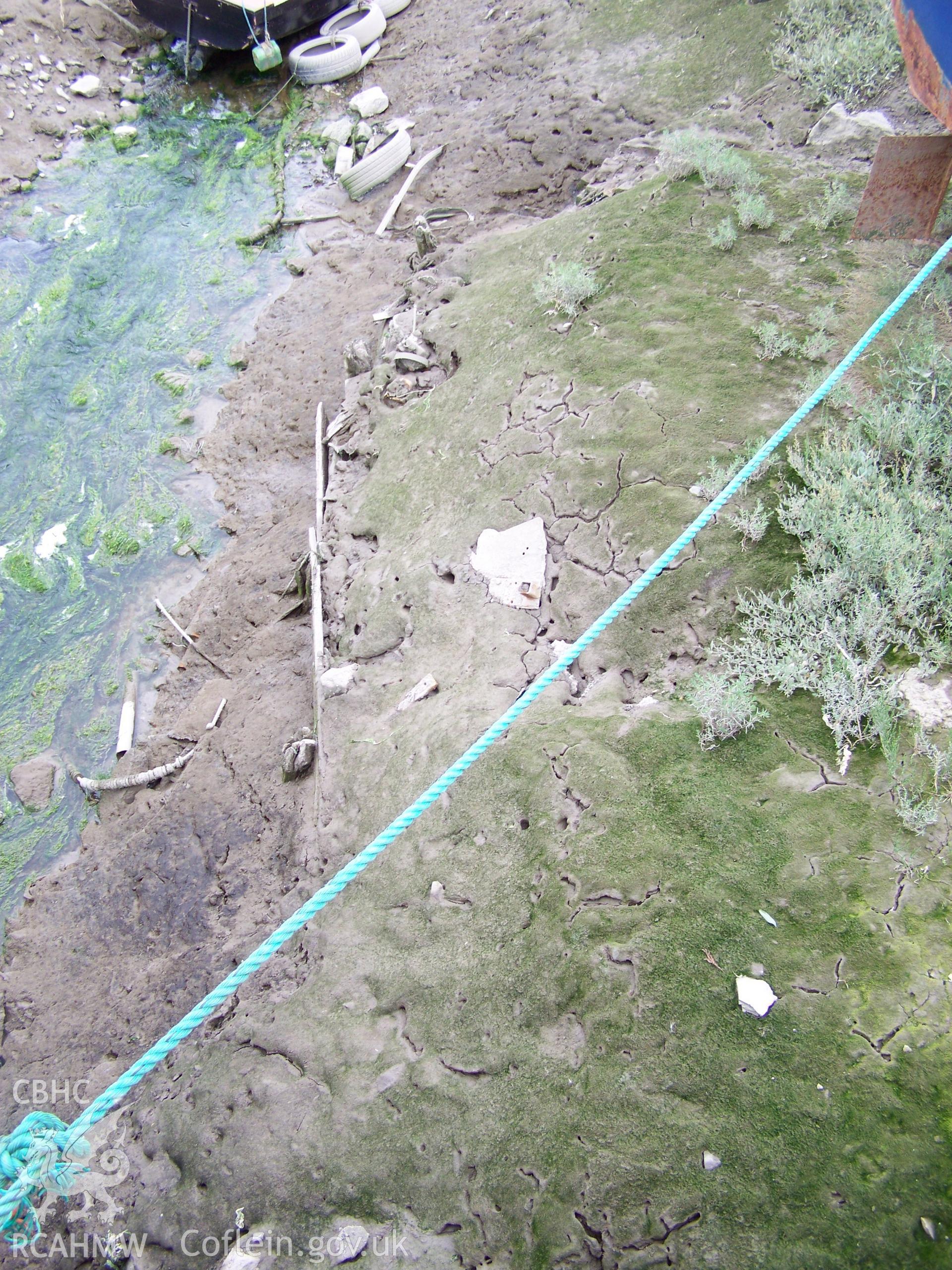 Planking (?) used to retain silt from mouth of former sluice