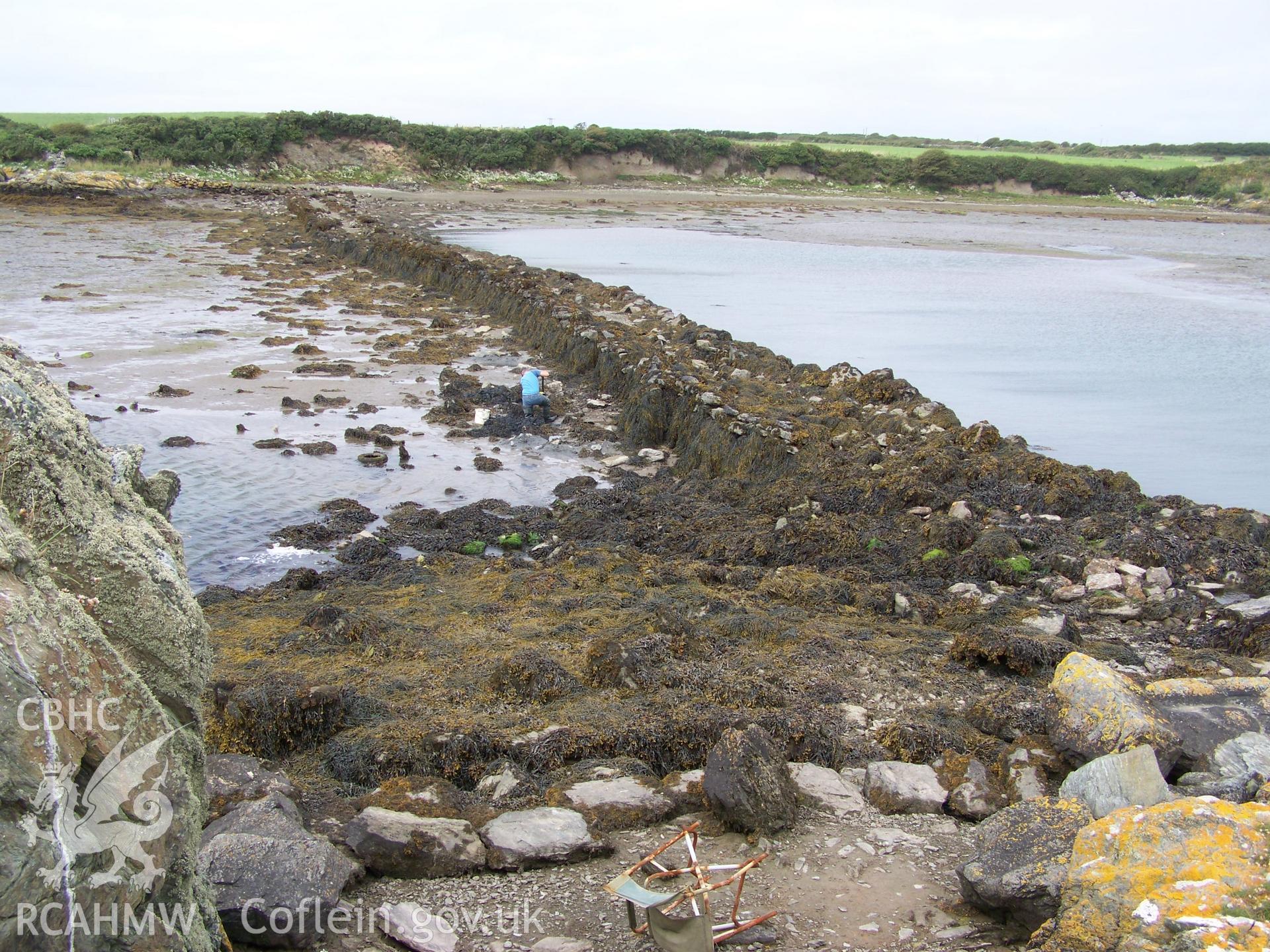 Retaining dam looking north from mill bulding paltform, with lowest later of foundation stones in the foreground