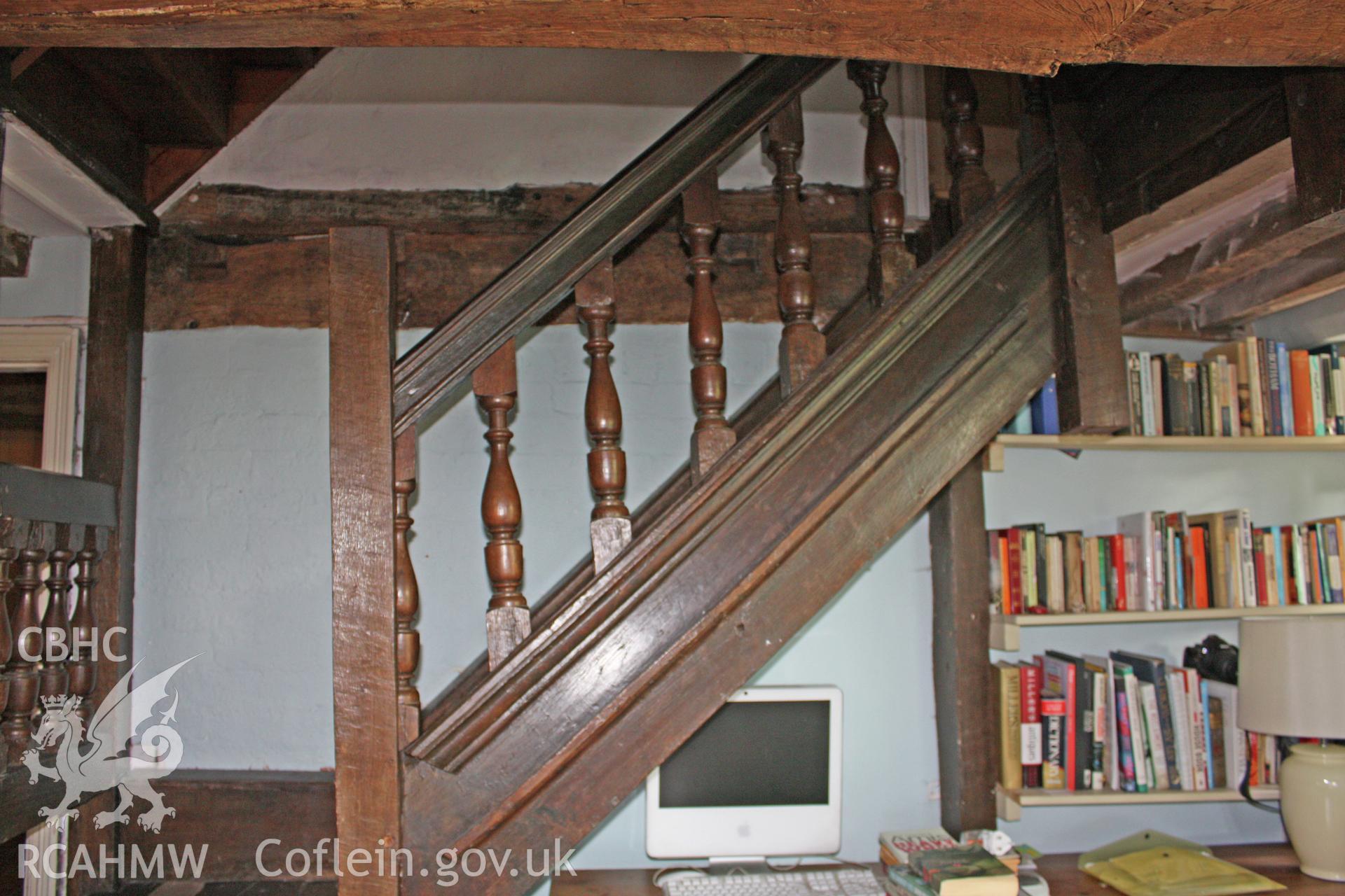 Reset 17th century stair against service room partition in hall/kitchen