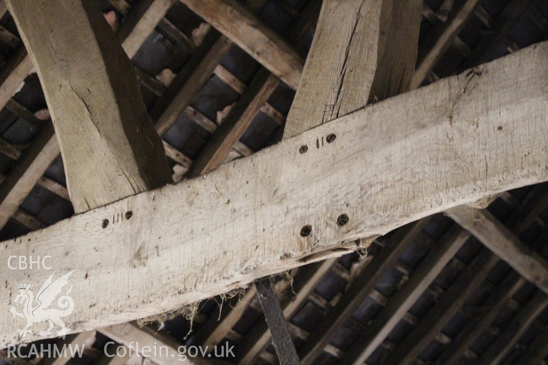 Interior; detail of pegging to raking struts and mortices for partition, also showing carpenters marks.