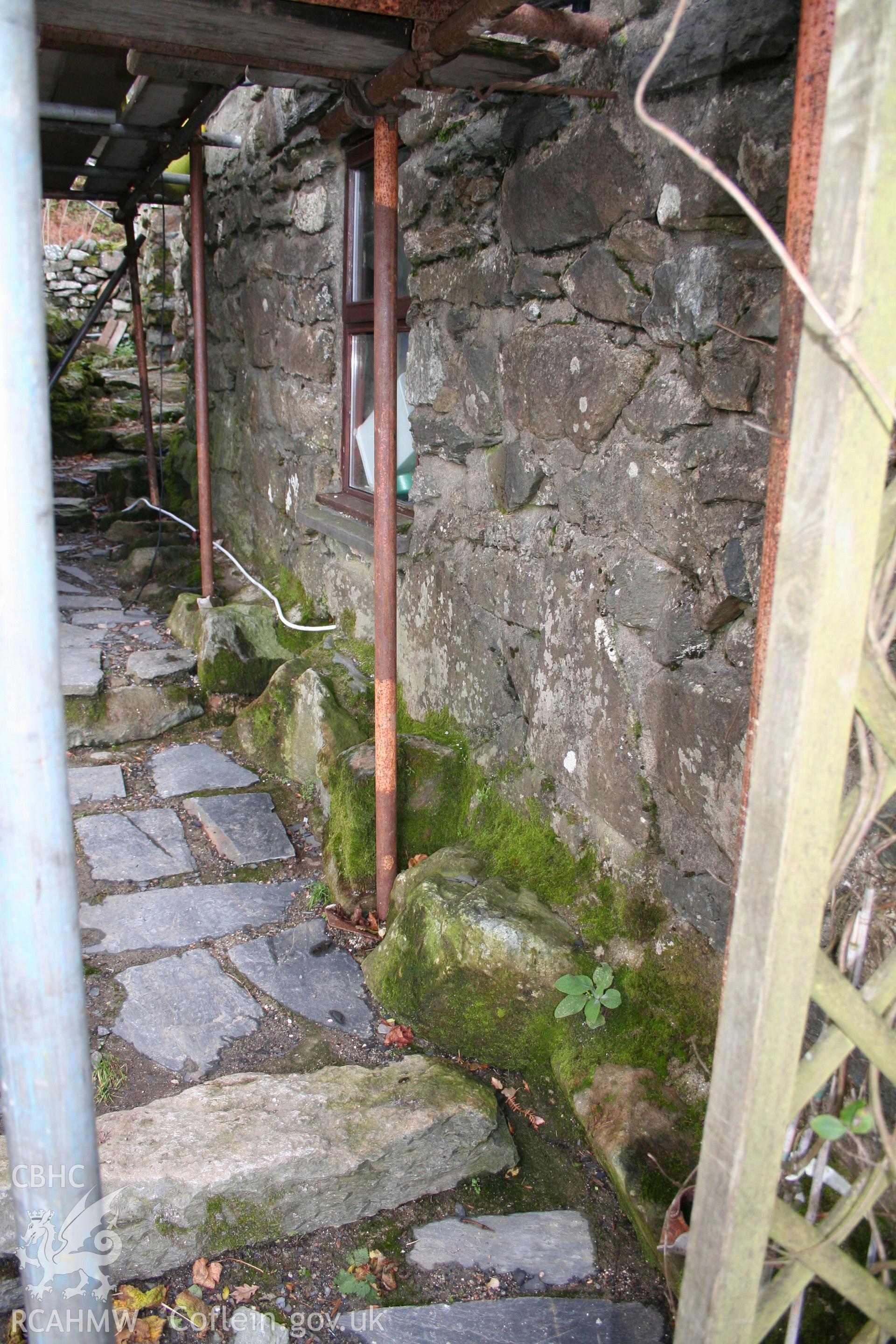 Exterior: south elevation, showing boulder stone base.