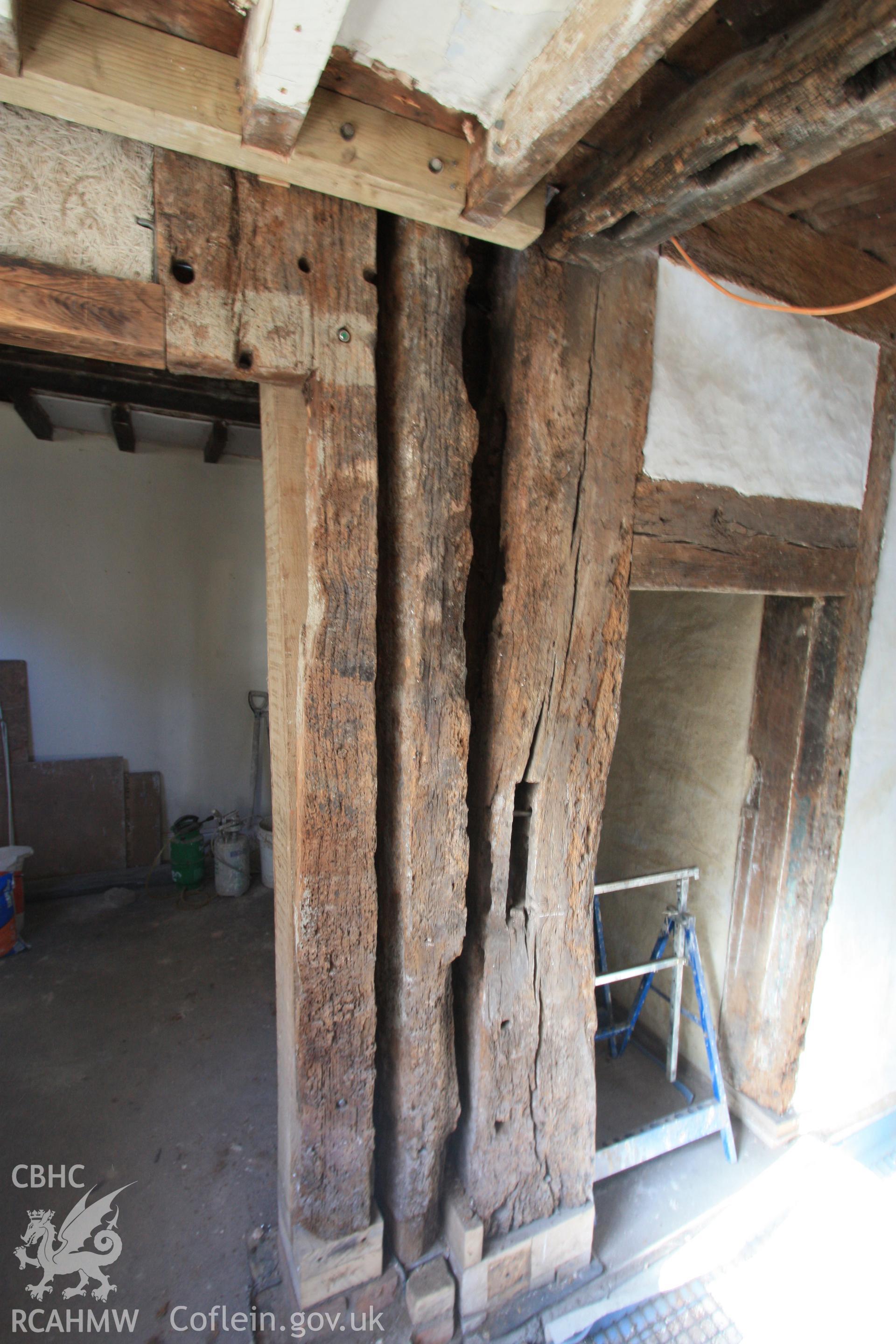 Interior: posts of hall to left and crosswing to right.