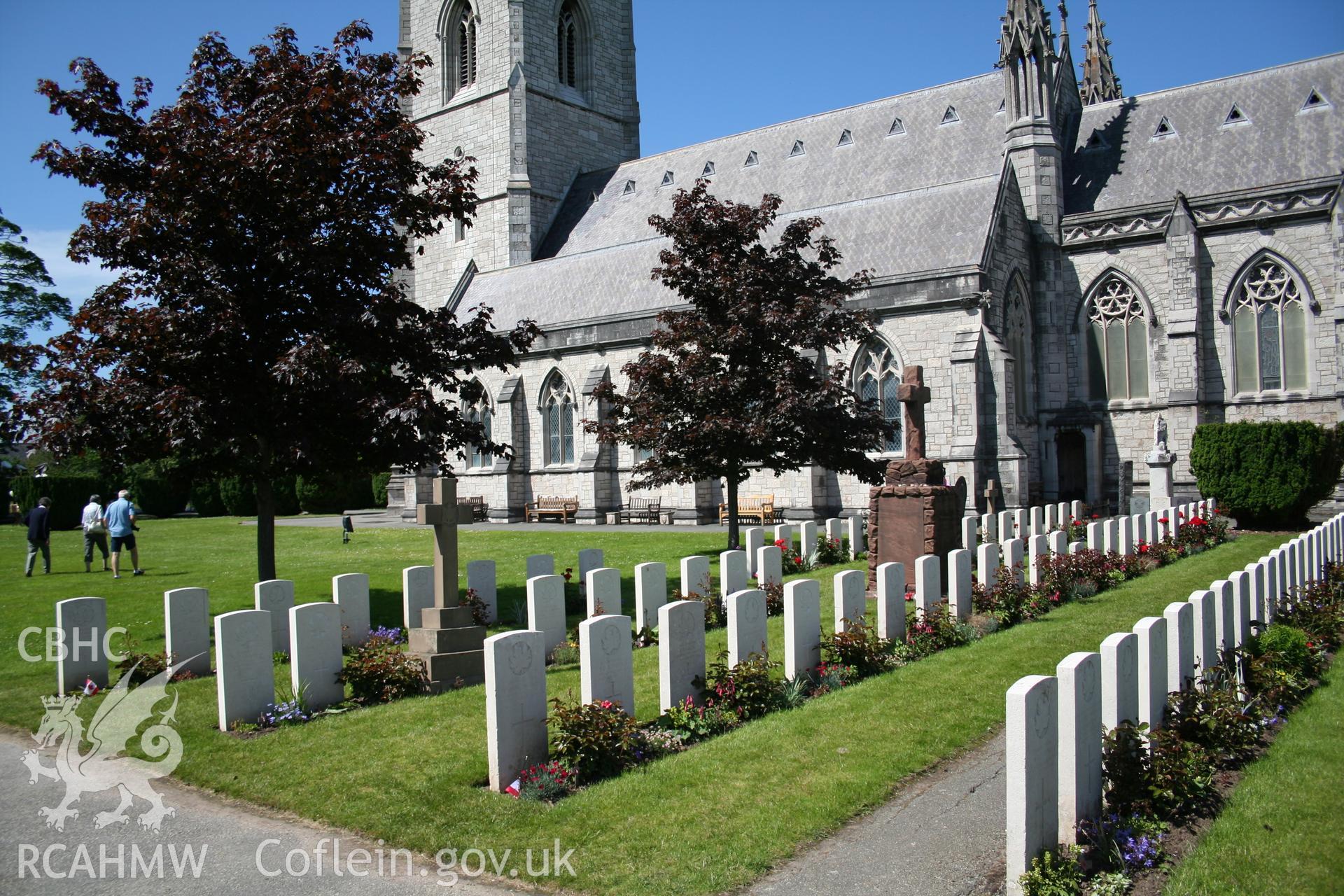 Canadian war graves and memorial, viewed from the south: flanked on west side by two maple trees.