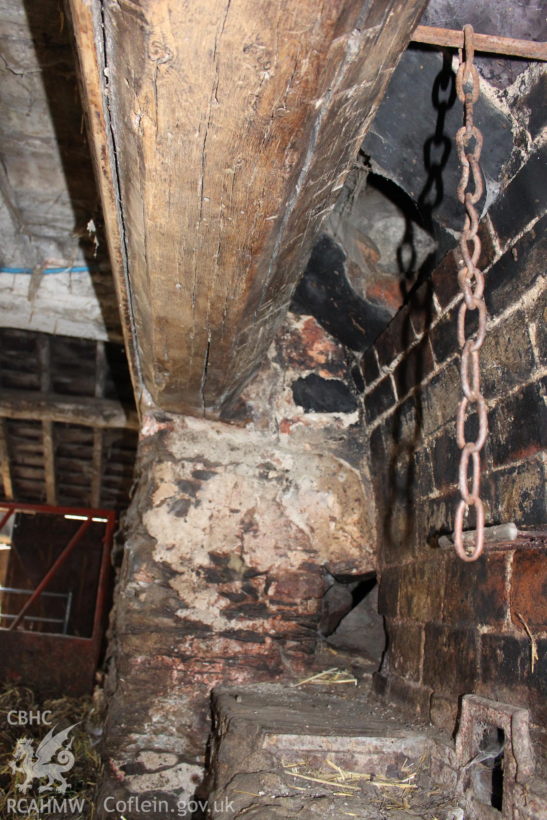 Interior; detail of bressummer and brick-backed fireplace