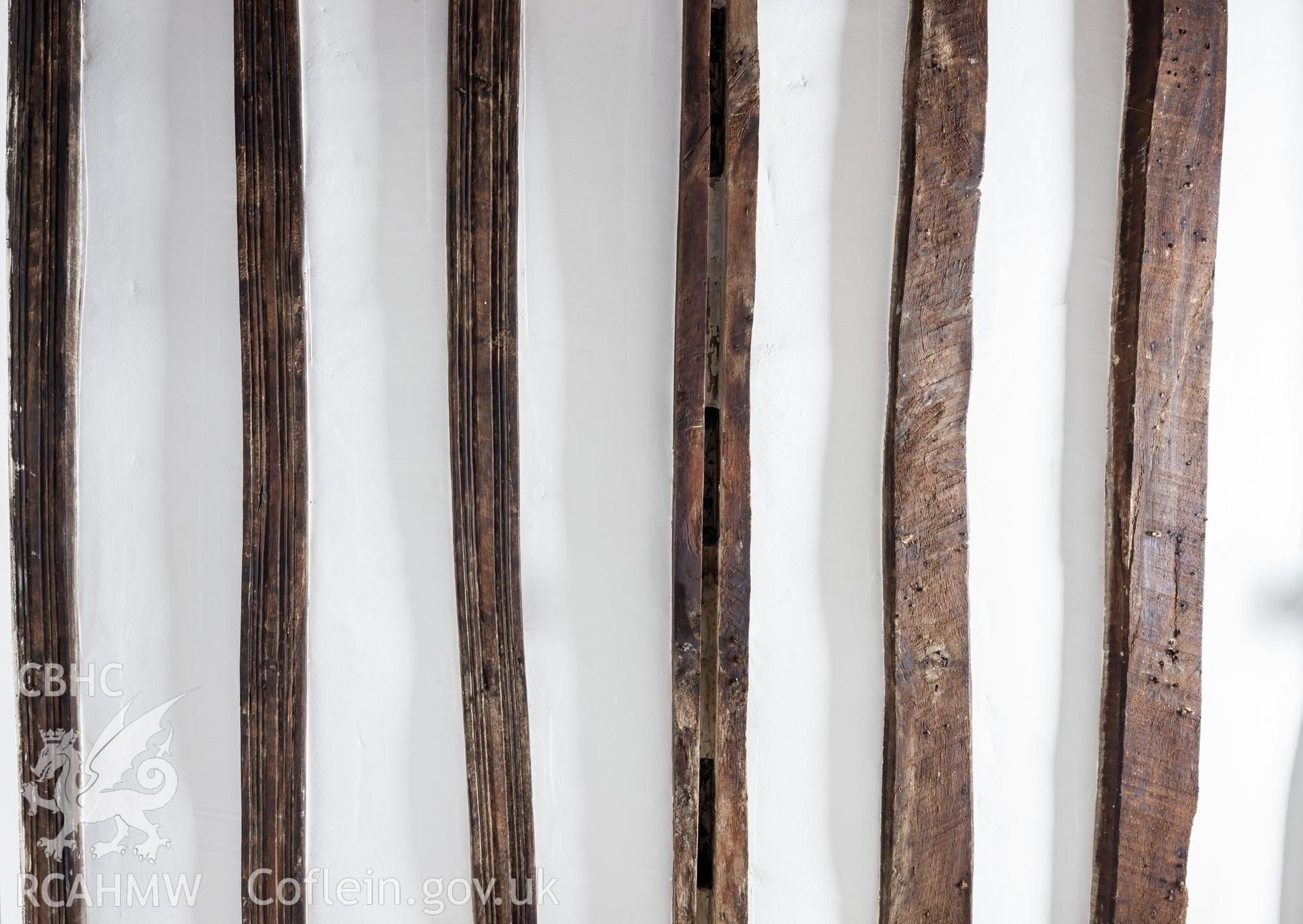 Kitchen ceiling, showing decorated joists, dividing panel support with mortice slots, and plain joists.