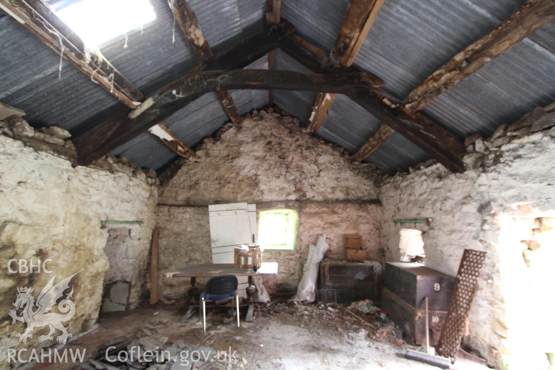 Interior: later truss with collar made from former cruck, ledge to gable wall for supporting joists of a crog-loft.